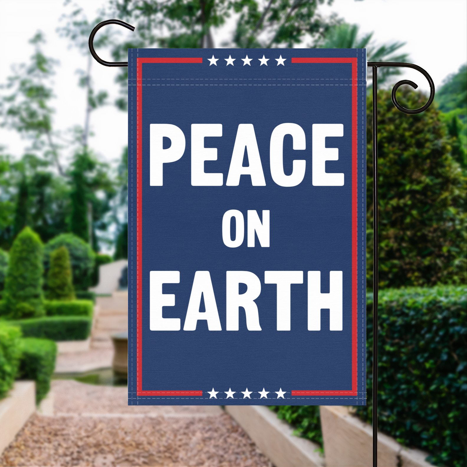 A red, white and blue political garden flag with the slogan Peace On Earth.