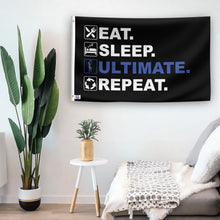 Load image into Gallery viewer, In a home setting, a flag with the saying &quot;Eat Sleep Ultimate Frisbee Repeat&quot; is mounted on a white wall by a side table.
