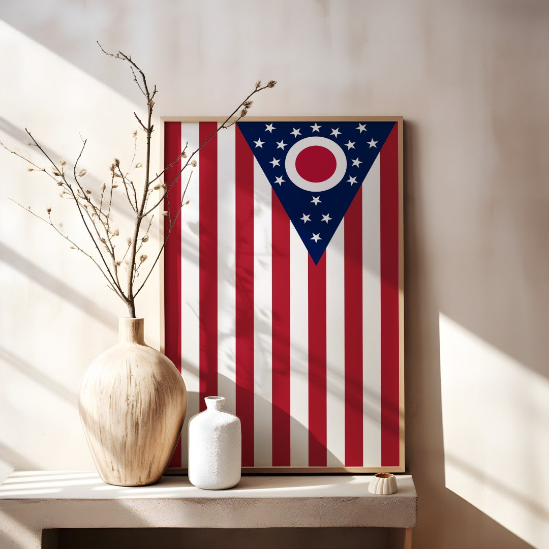 Blended US and Ohio flag print in a wooden frame, showcasing American stars & stripes merged with Ohio’s emblem, displayed on a tabletop.