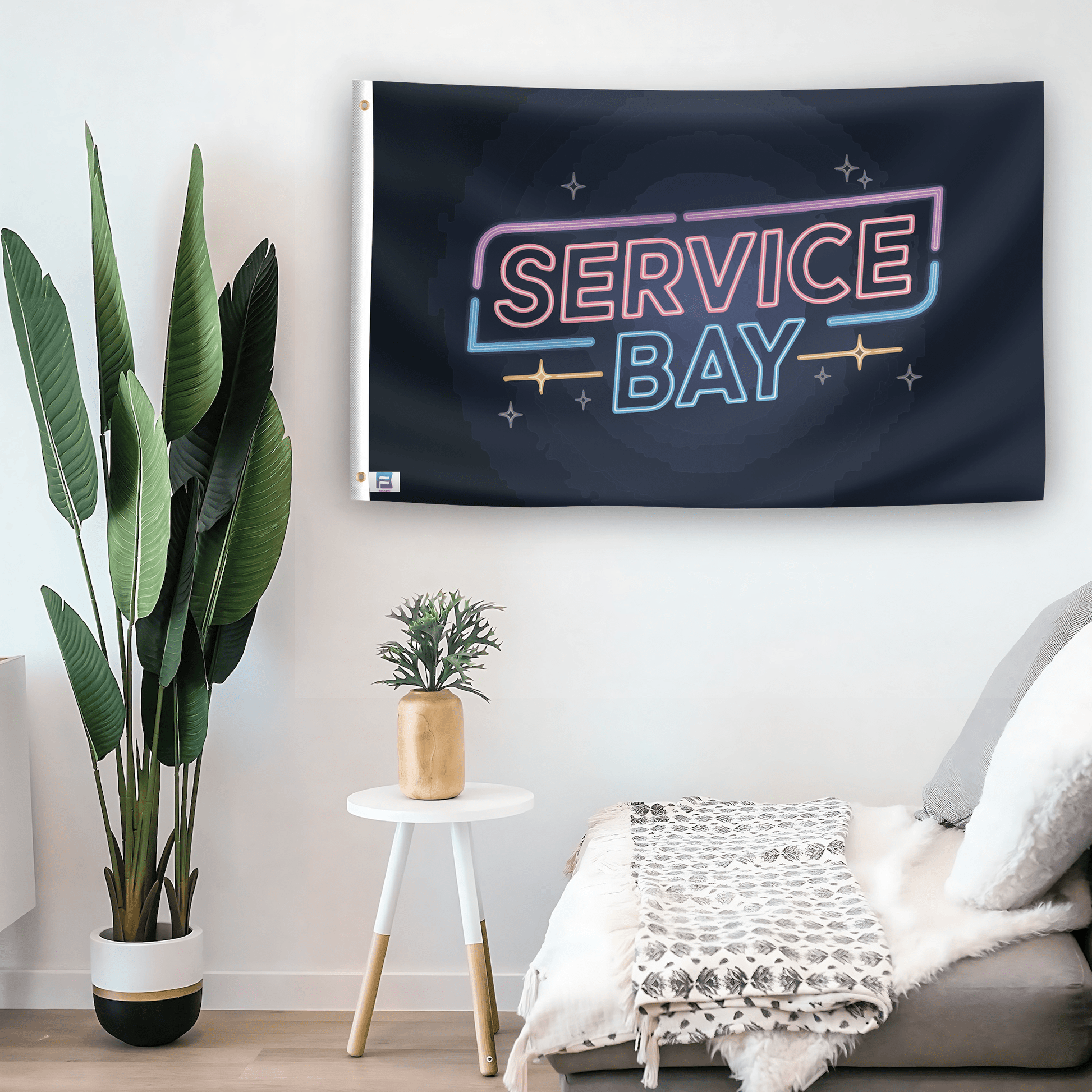 In a home setting, a flag with the saying "Service Bay" is mounted on a white wall by a side table.