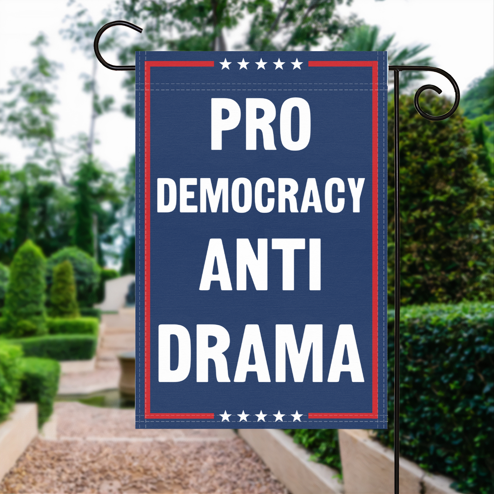 A red, white and blue political garden flag with the slogan Pro Democracy Anti Drama.