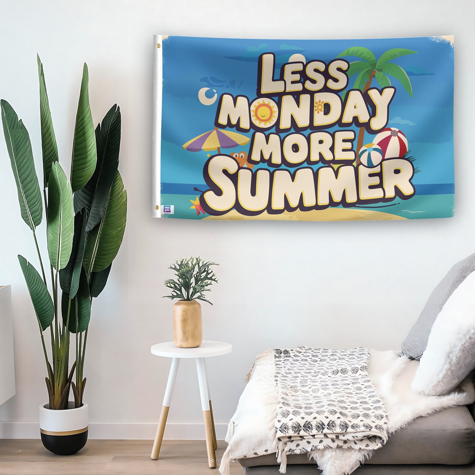 In a home setting, a flag with the saying "Less Monday More Summer" is mounted on a white wall by a side table.