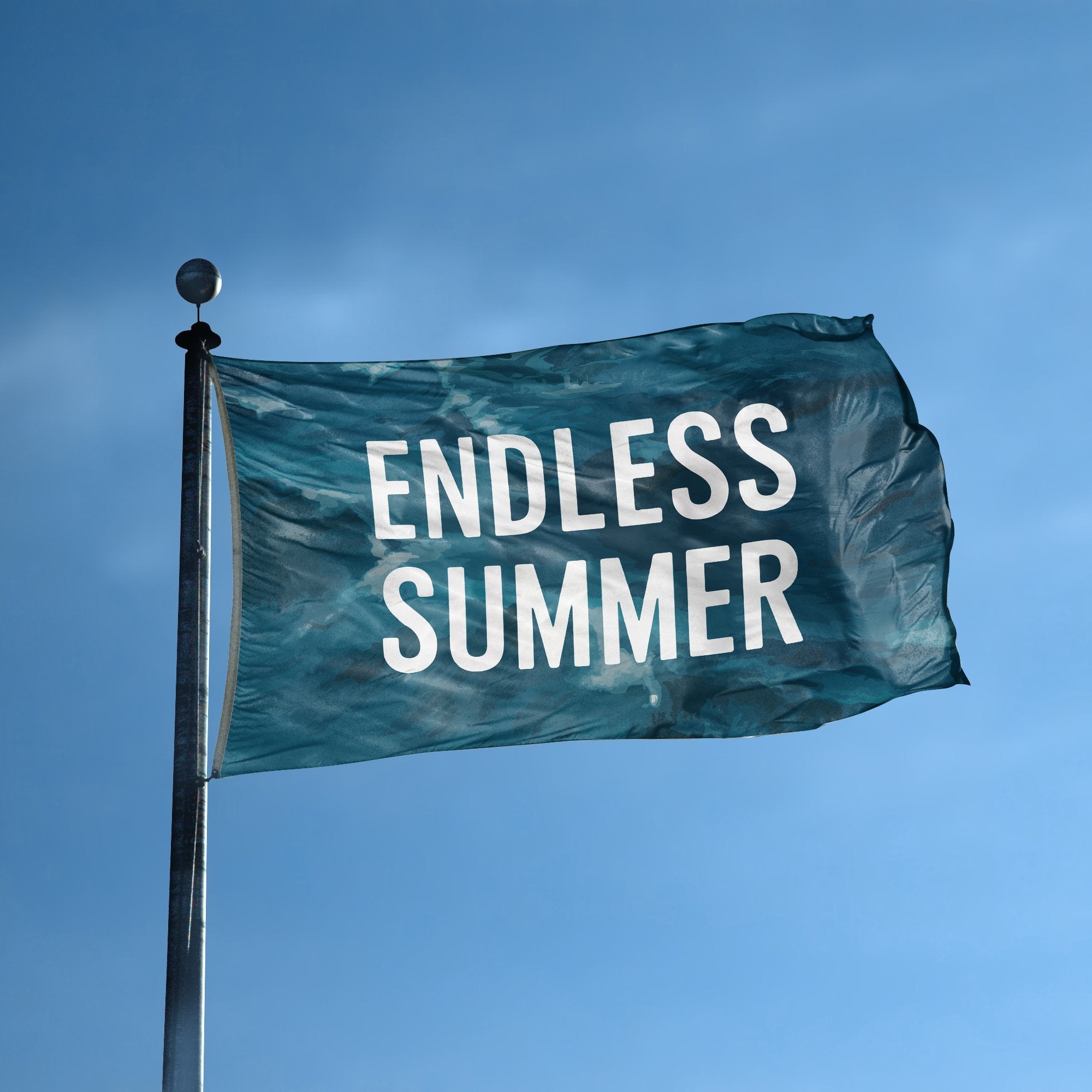 A flag with the saying "Endless Summer" displayed on a high pole, with a special occasion color scheme.