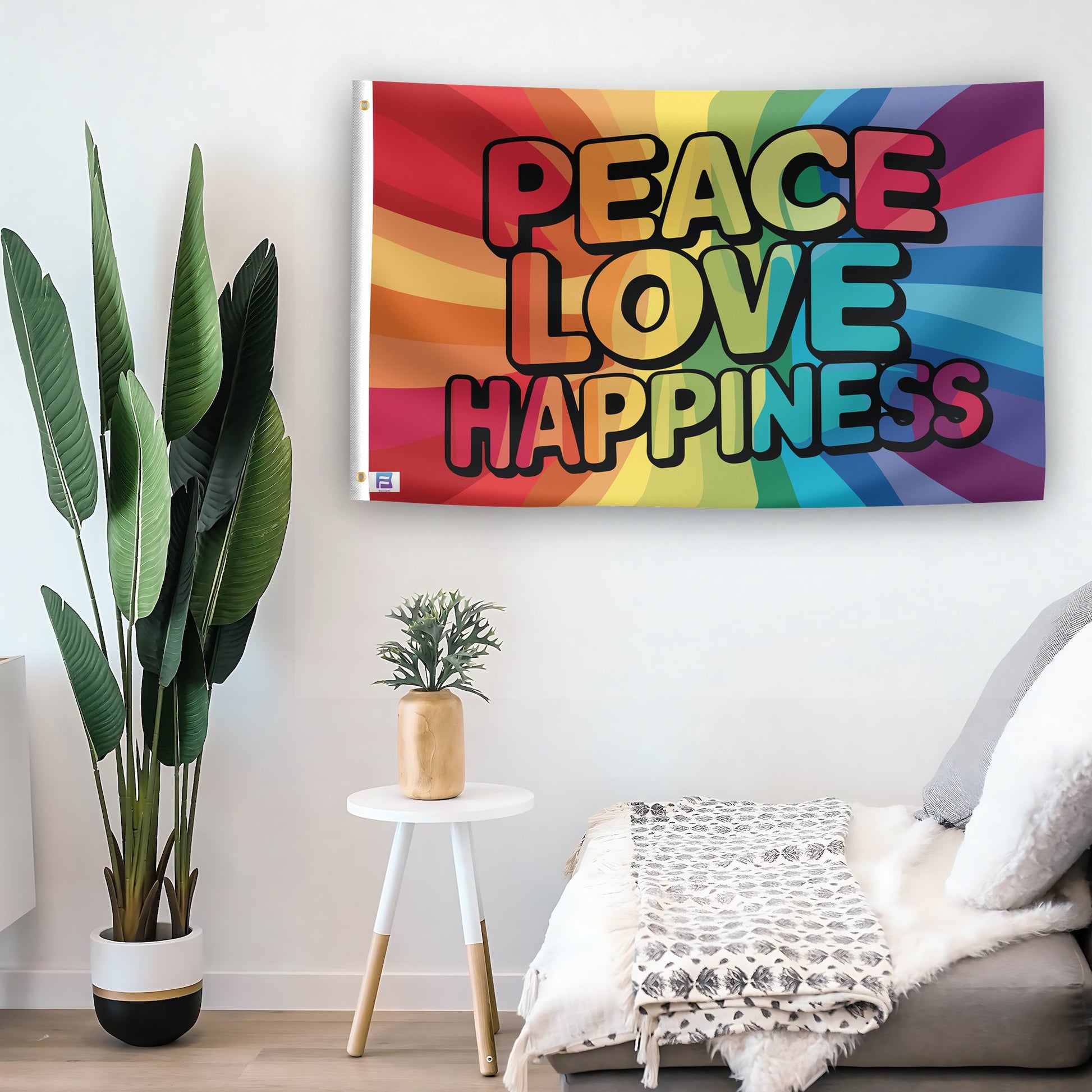 In a home setting, a flag with the saying "Peace Love Happiness Rainbow" is mounted on a white wall by a side table.