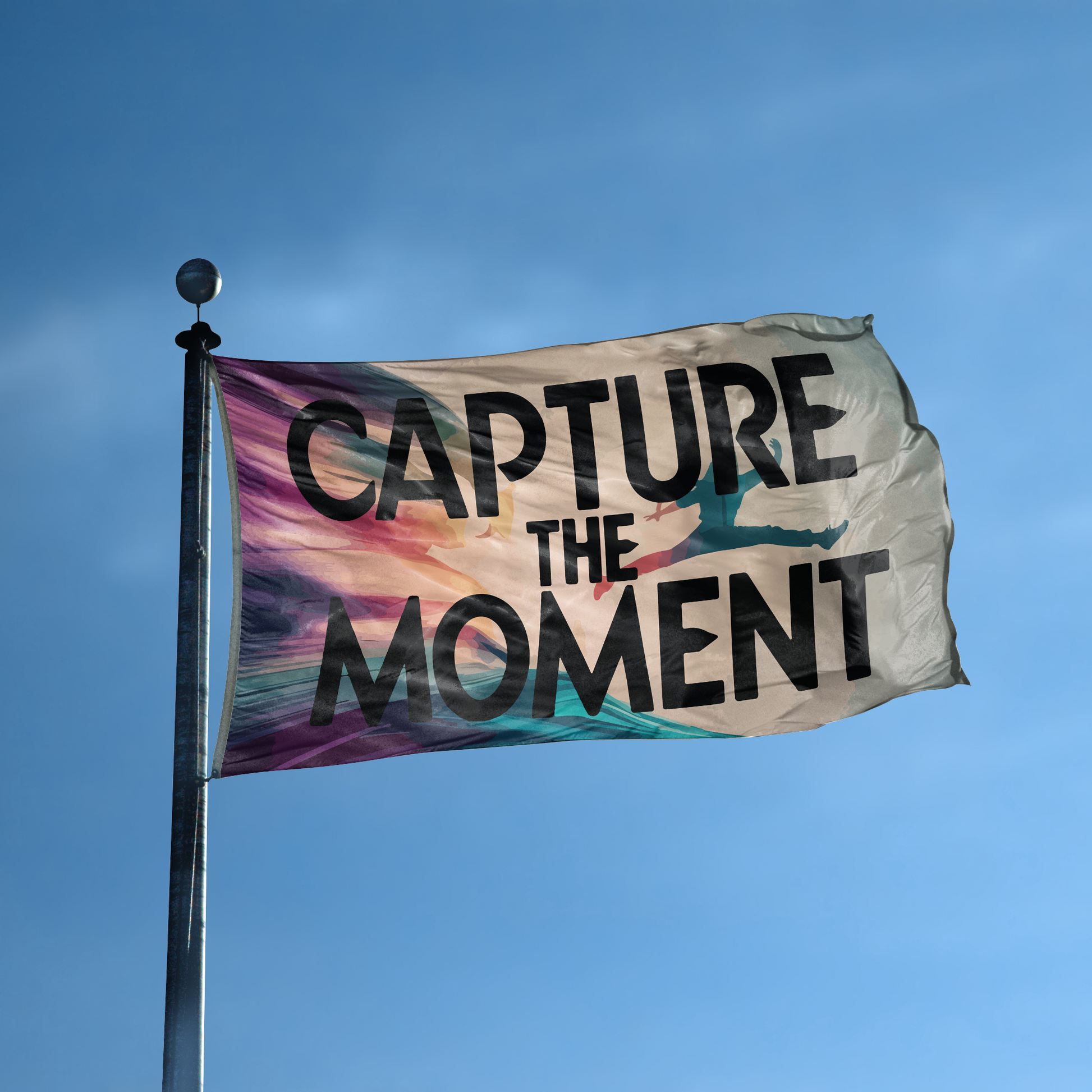 A flag with the saying "Capture The Moment" displayed on a high pole, with a special occasion color scheme.