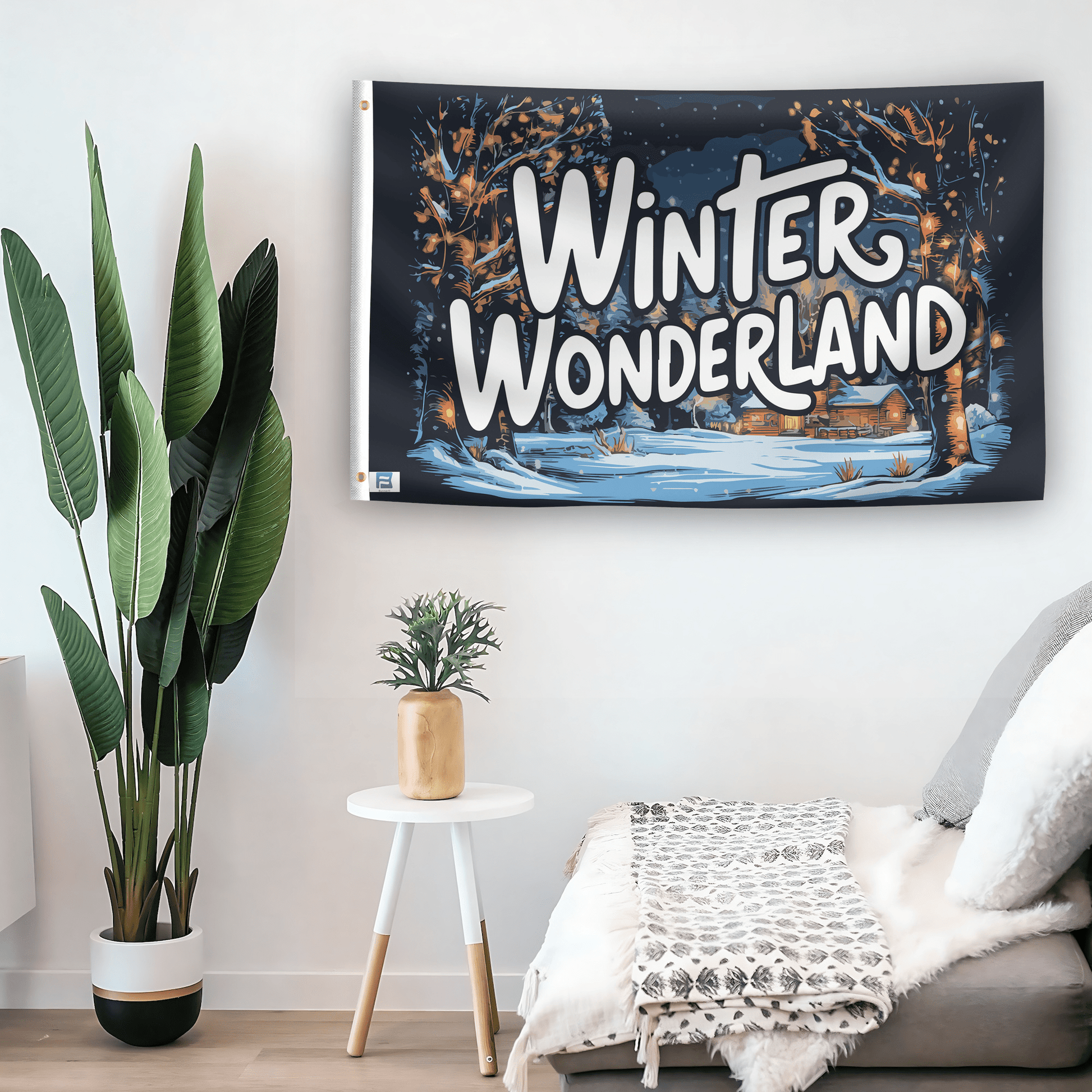 In a home setting, a flag with the saying "Winter Wonderland Seasonal" is mounted on a white wall by a side table.