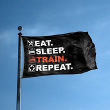 Load image into Gallery viewer, A flag with the saying &quot;Eat Sleep Train Repeat&quot; displayed on a high pole, with a black, white and themed color scheme.
