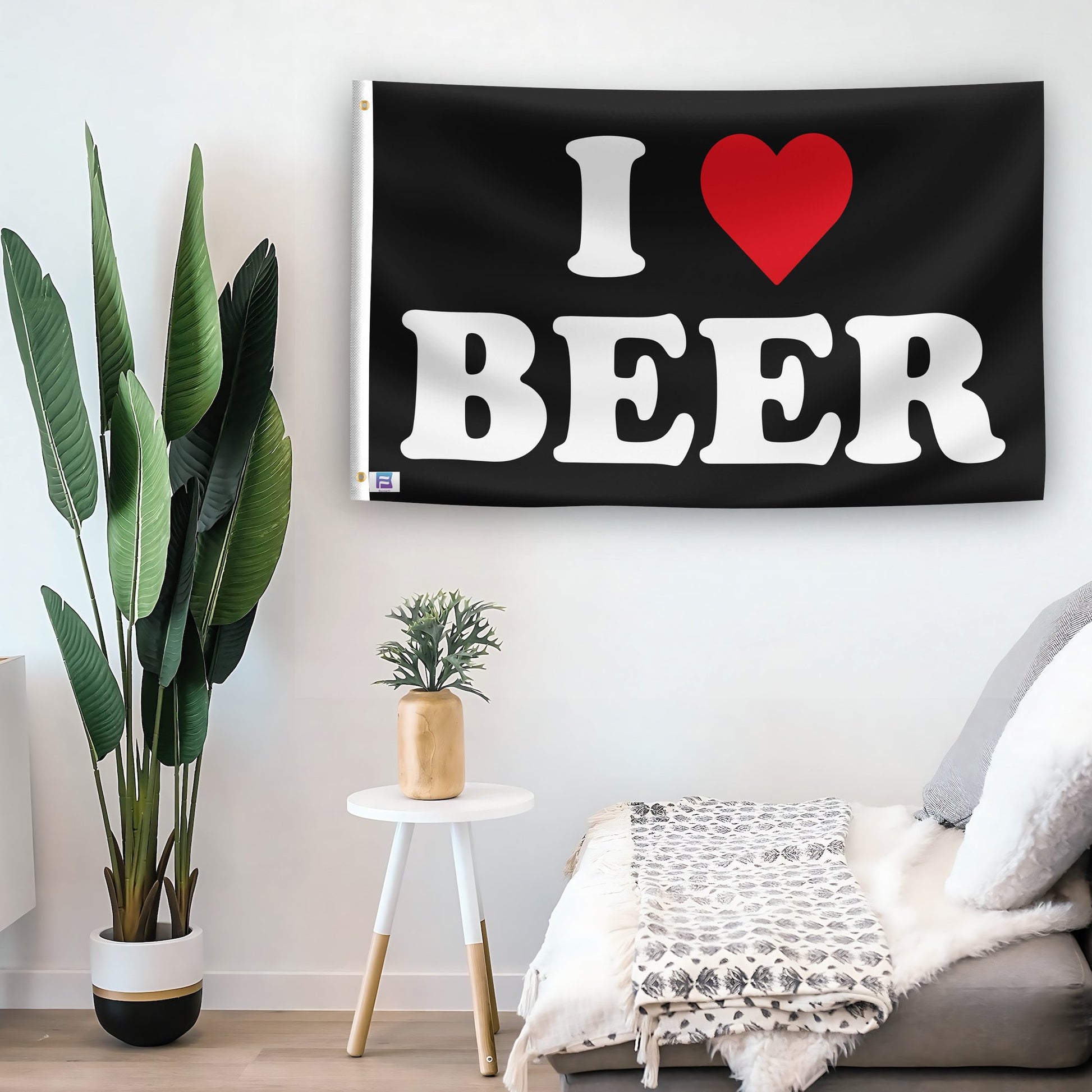 In a home setting, a flag with the saying "I Love Beer" is mounted on a white wall by a side table.