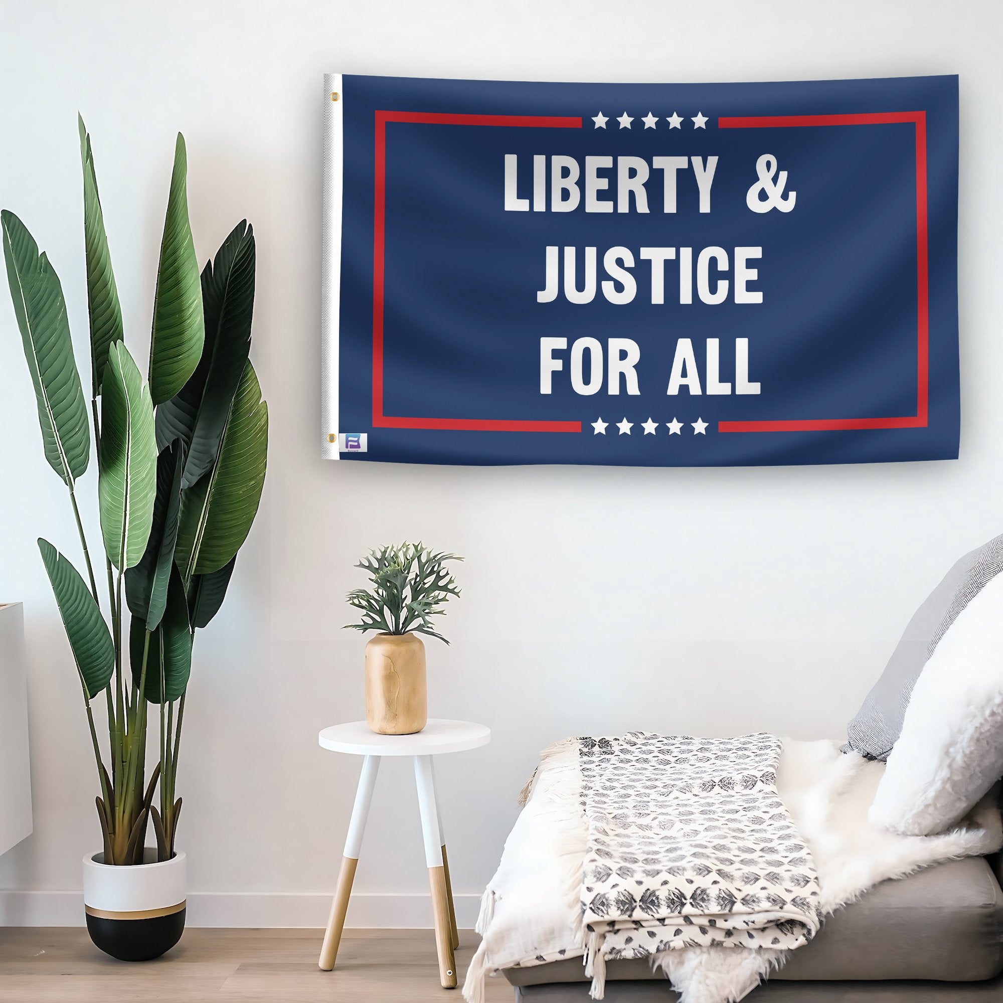 In a home setting, a flag with the saying "Liberty And Justice For All Political" is mounted on a white wall by a side table.