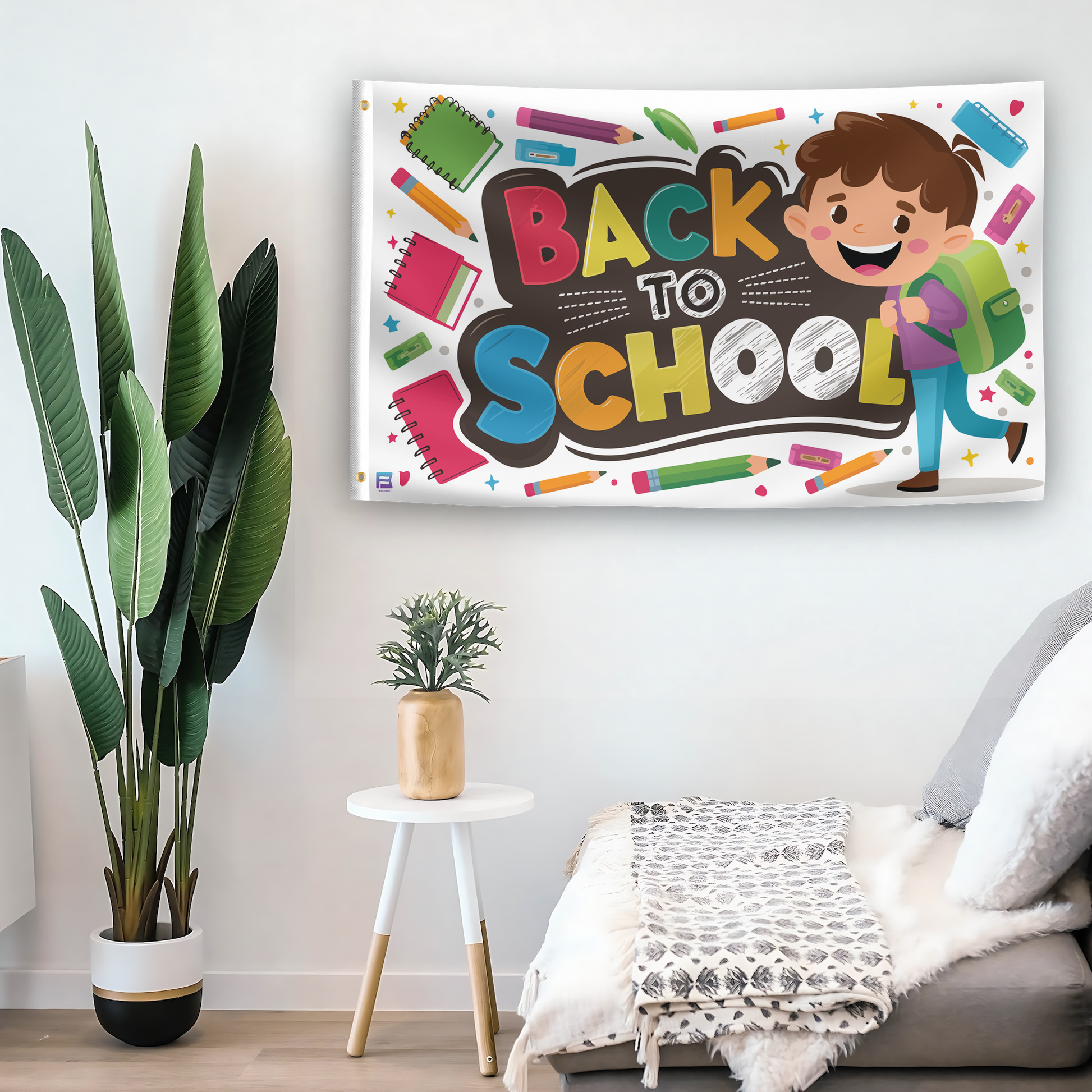 In a home setting, a flag with the saying "Back To School" is mounted on a white wall by a side table.