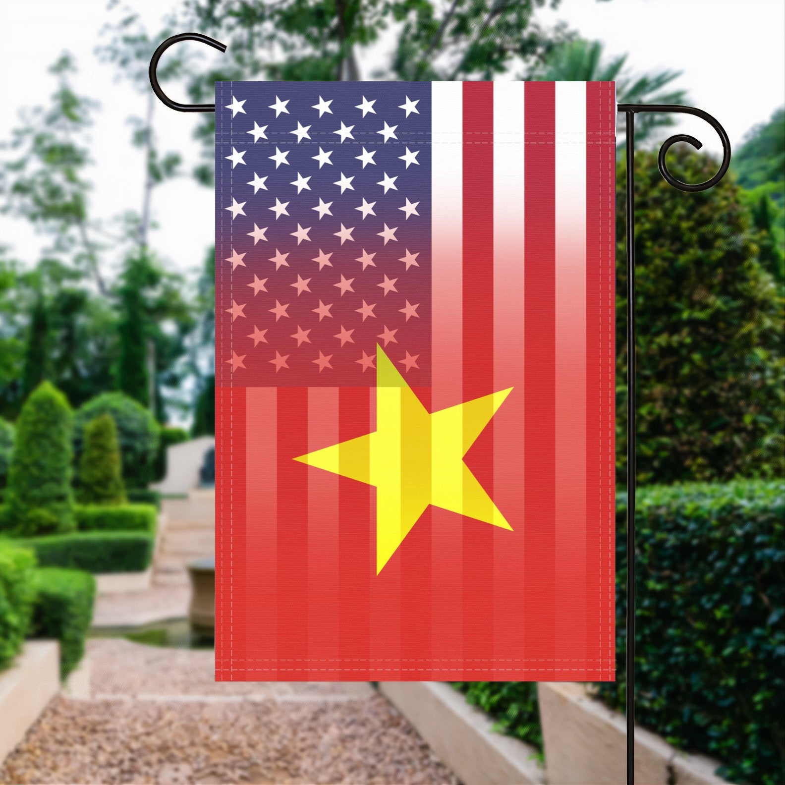 A garden flag with the Vietnamese American flag design seamlessly blended with the American flag, displayed in a garden.