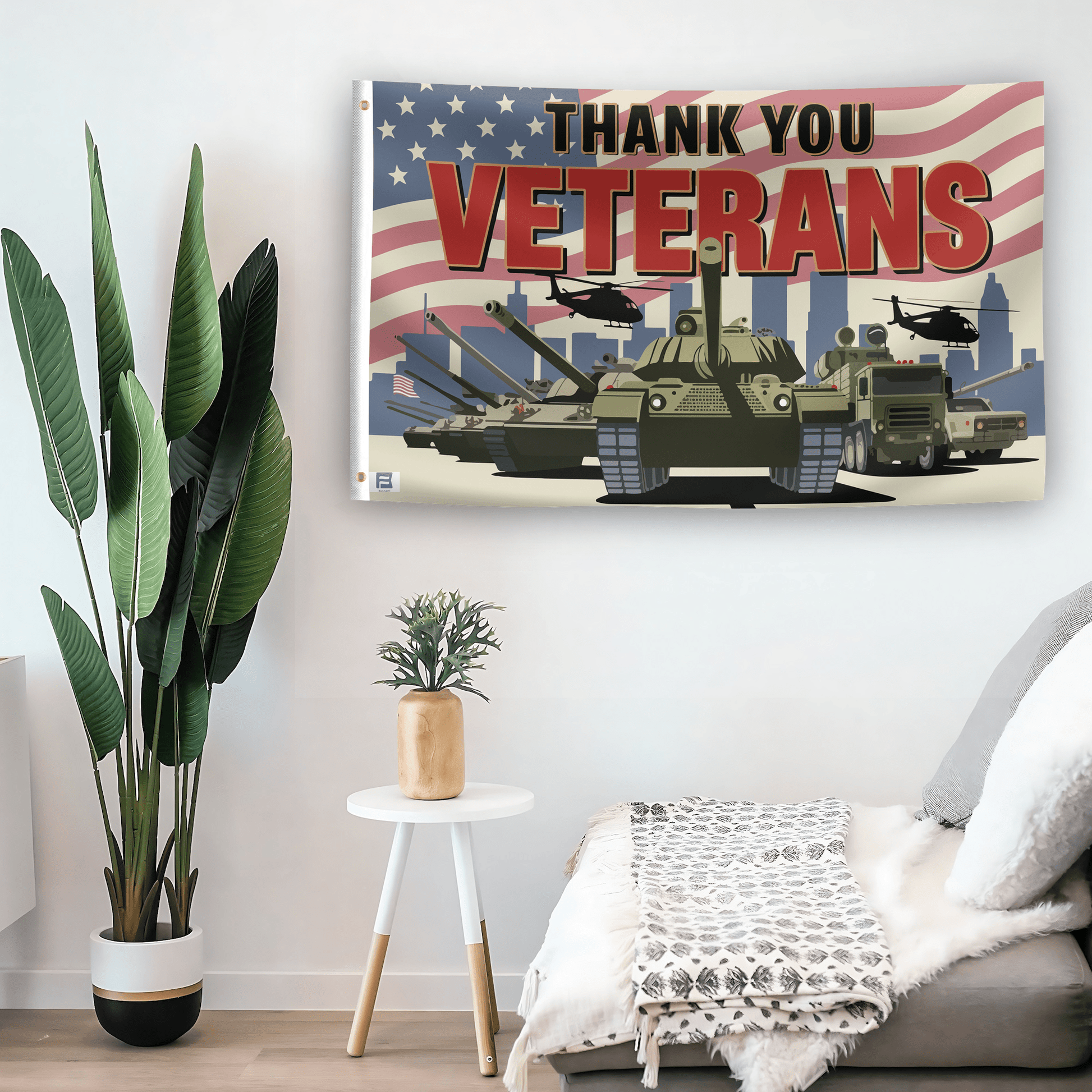 In a home setting, a flag with the saying "Thank You Veterans" is mounted on a white wall by a side table.