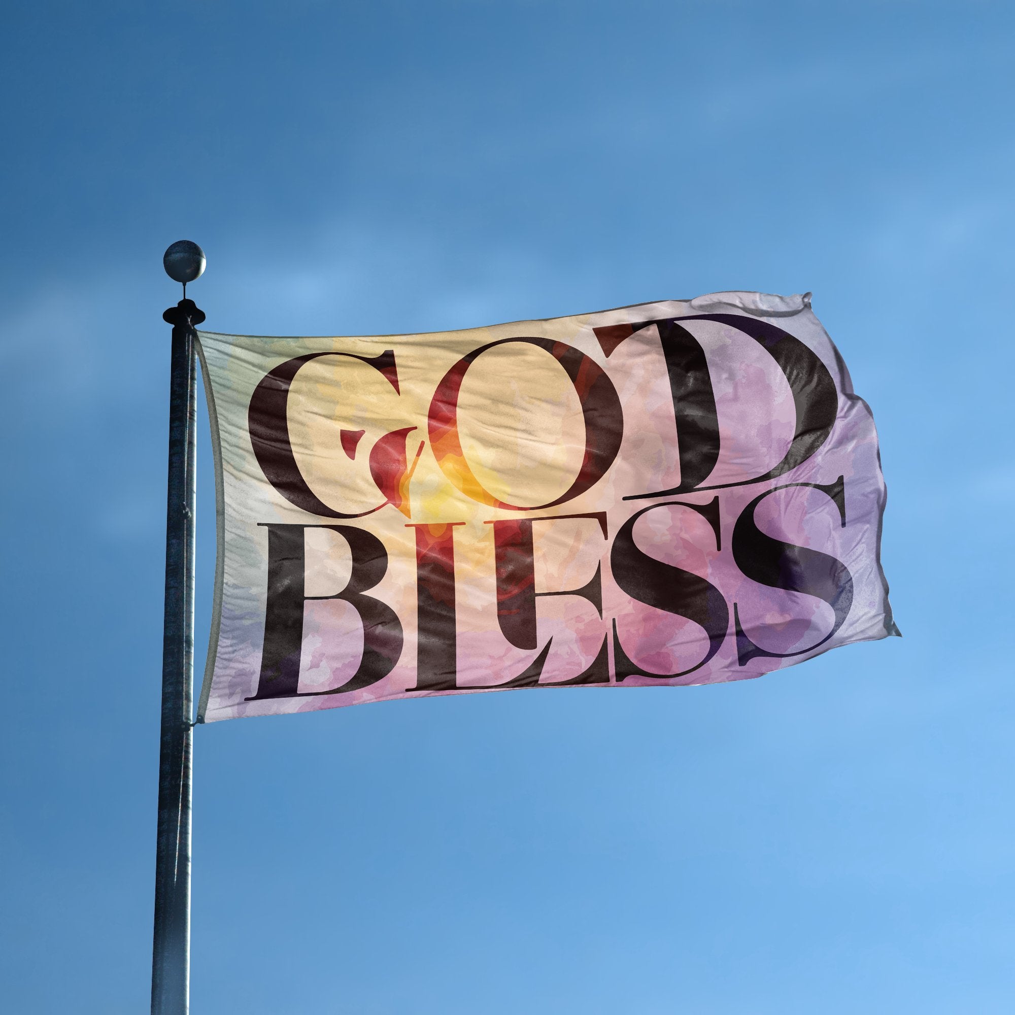 A flag with the saying "God Bless" displayed on a high pole, with a special occasion color scheme.