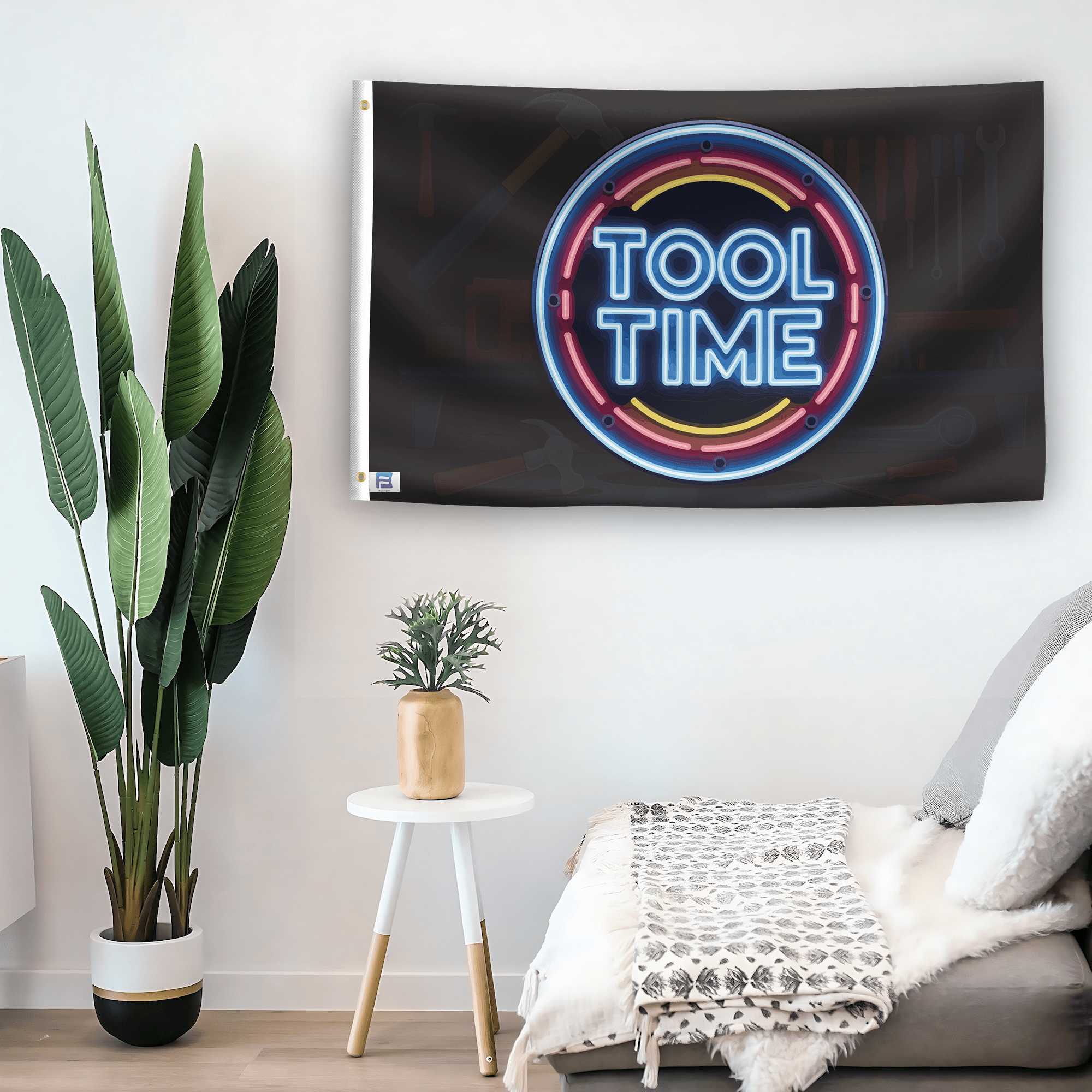 In a home setting, a flag with the saying "Tool Time" is mounted on a white wall by a side table.