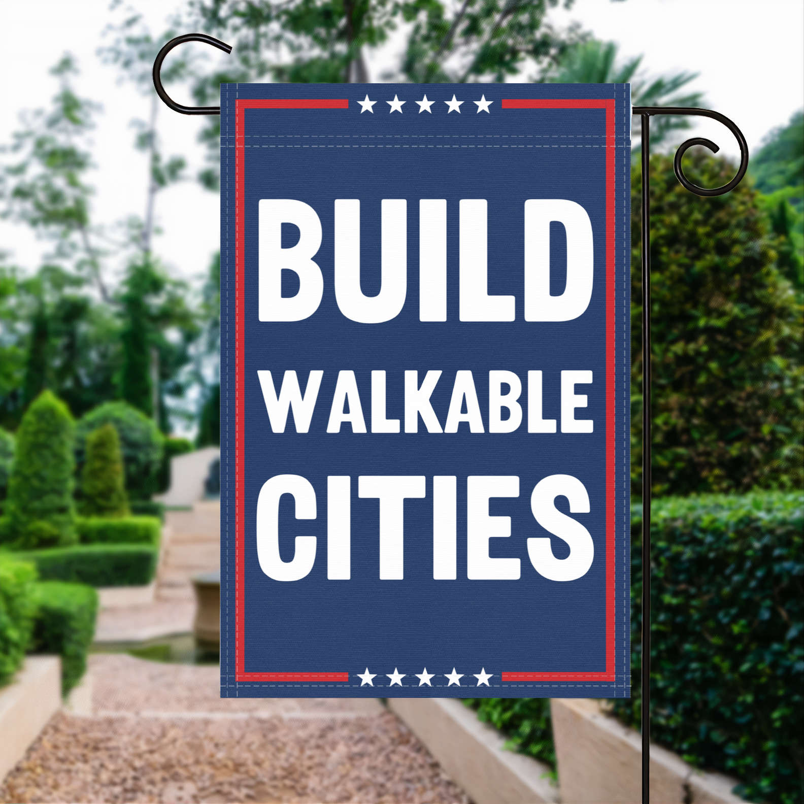 A red, white and blue political garden flag with the slogan Build Walkable Cities.