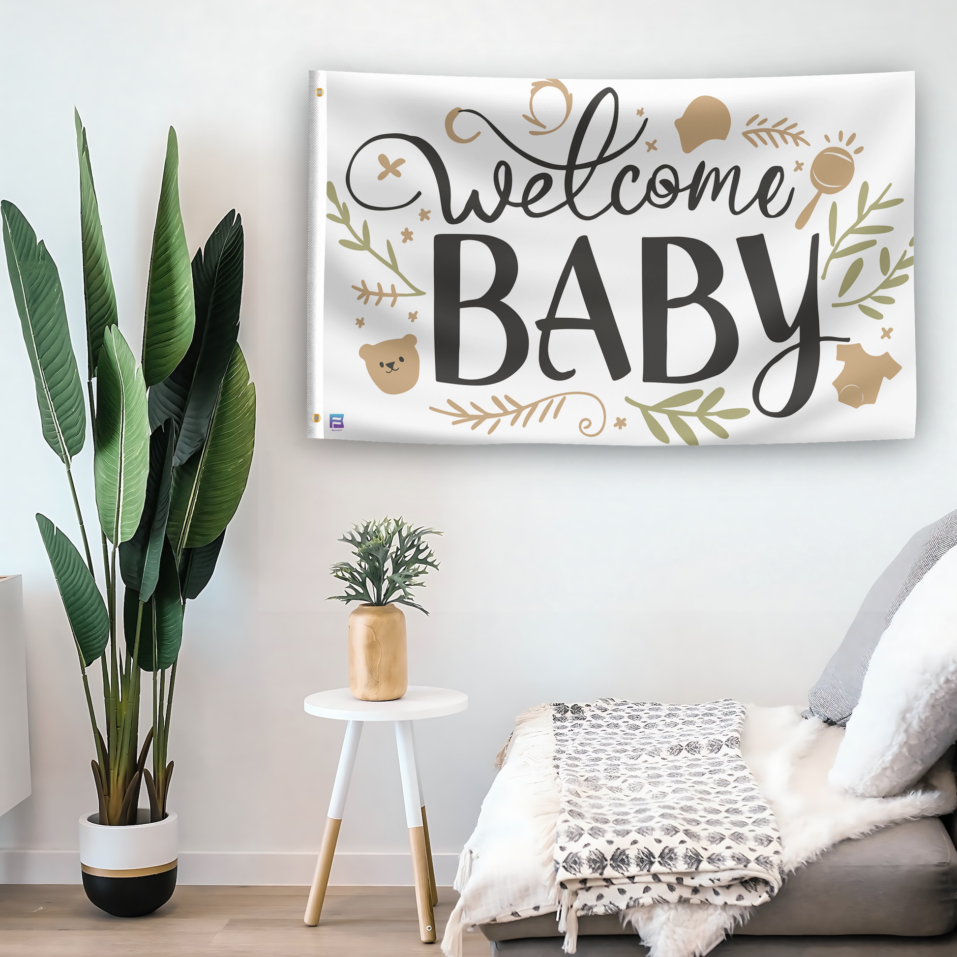 In a home setting, a flag with the saying "Welcome Baby" is mounted on a white wall by a side table.