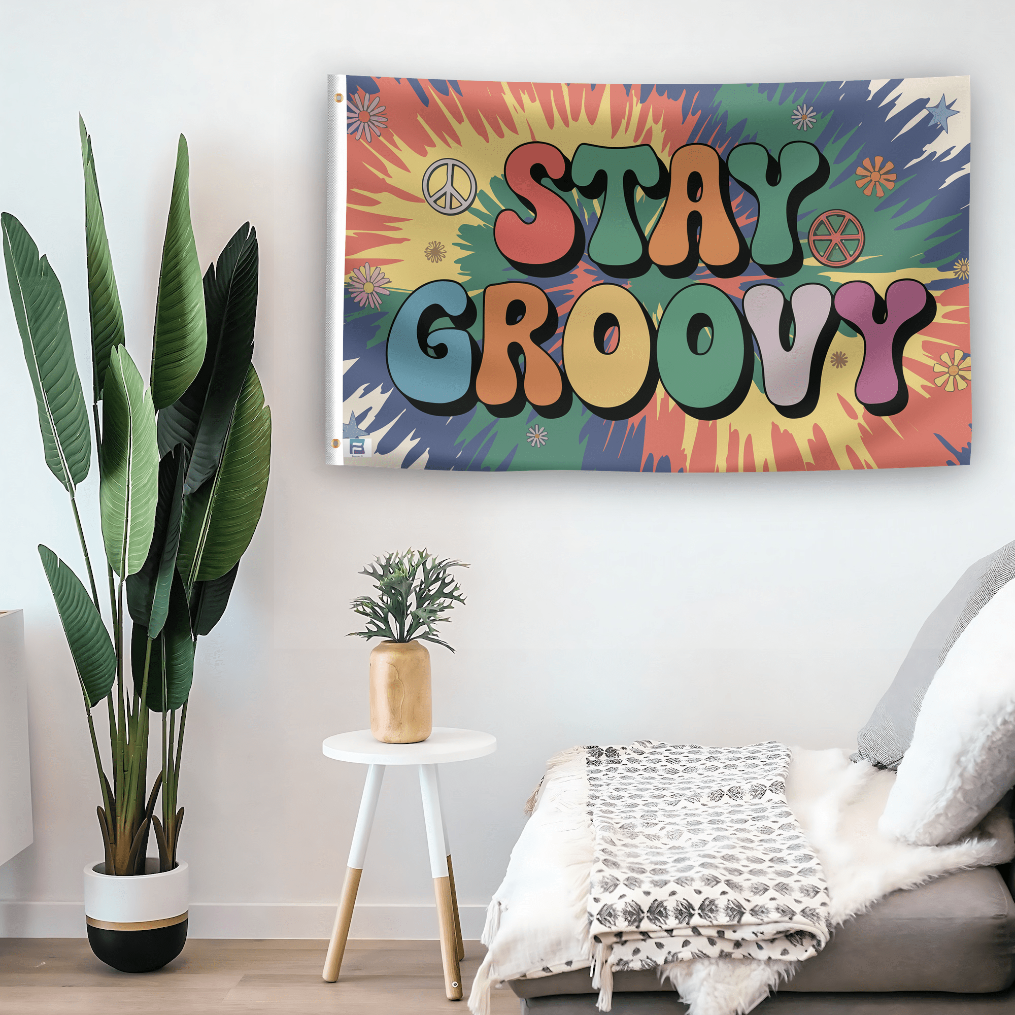 In a home setting, a flag with the saying "Stay Groovy" is mounted on a white wall by a side table.