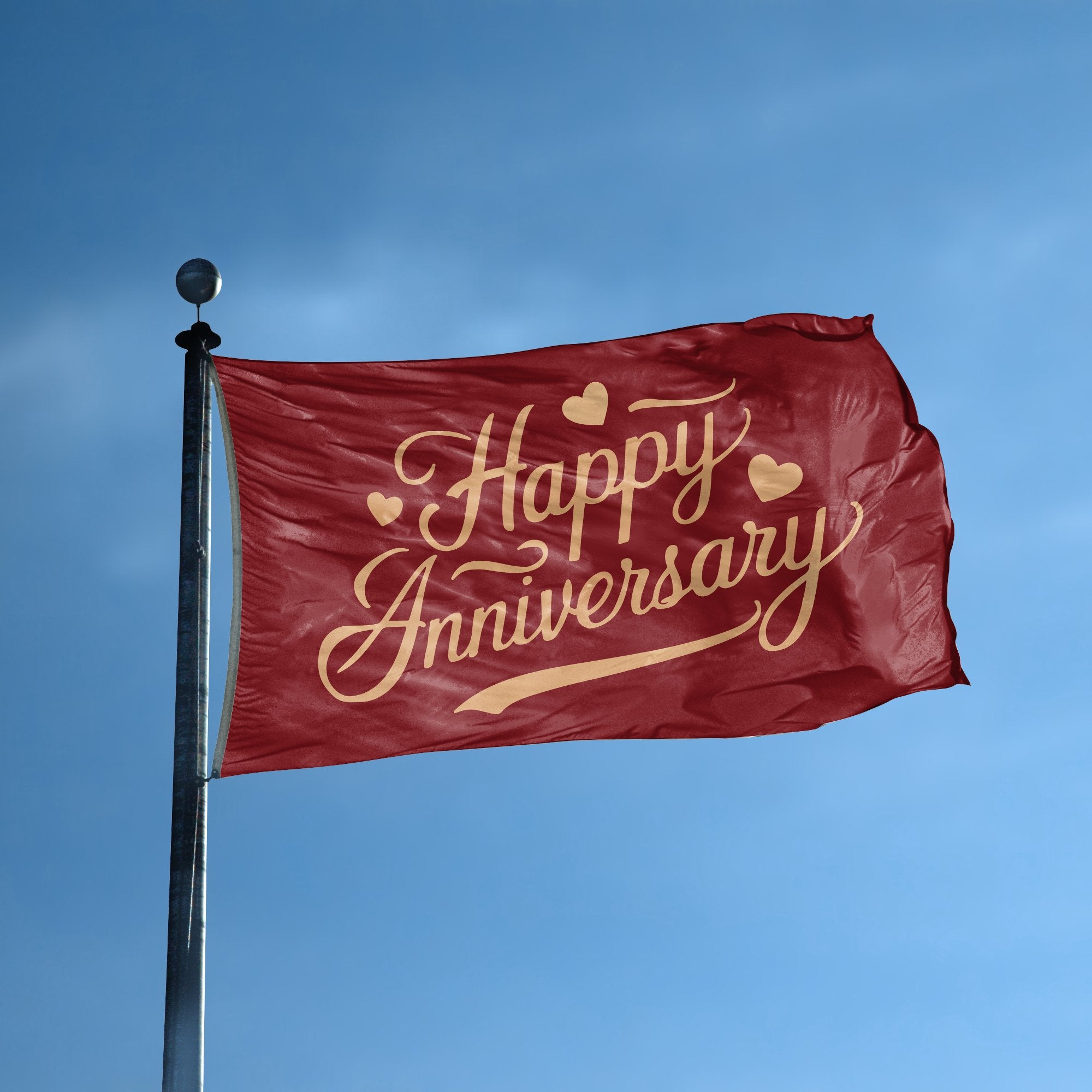 A flag with the saying "Happy Anniversary" displayed on a high pole, with a special occasion color scheme.