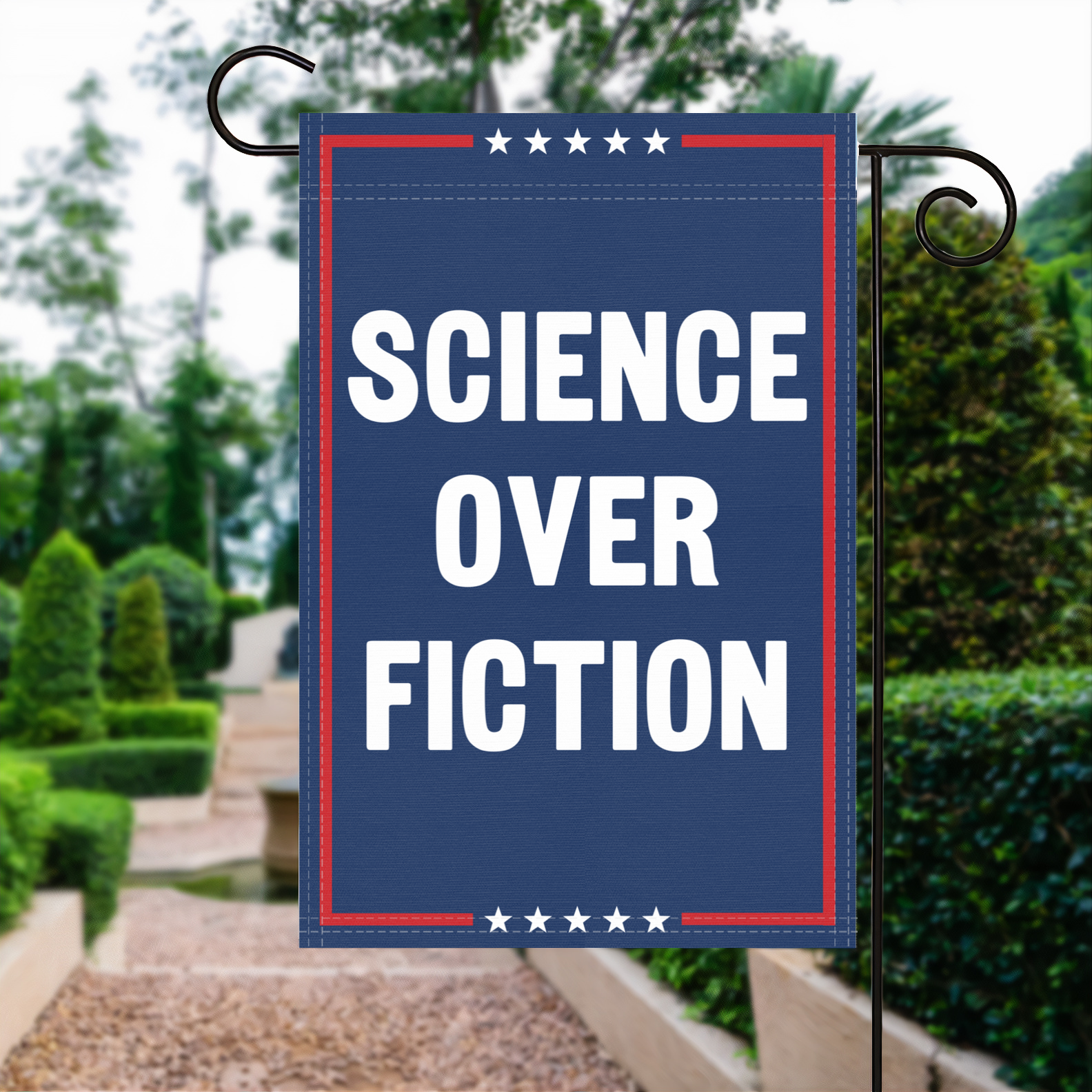 A red, white and blue political garden flag with the slogan Science Over Fiction.