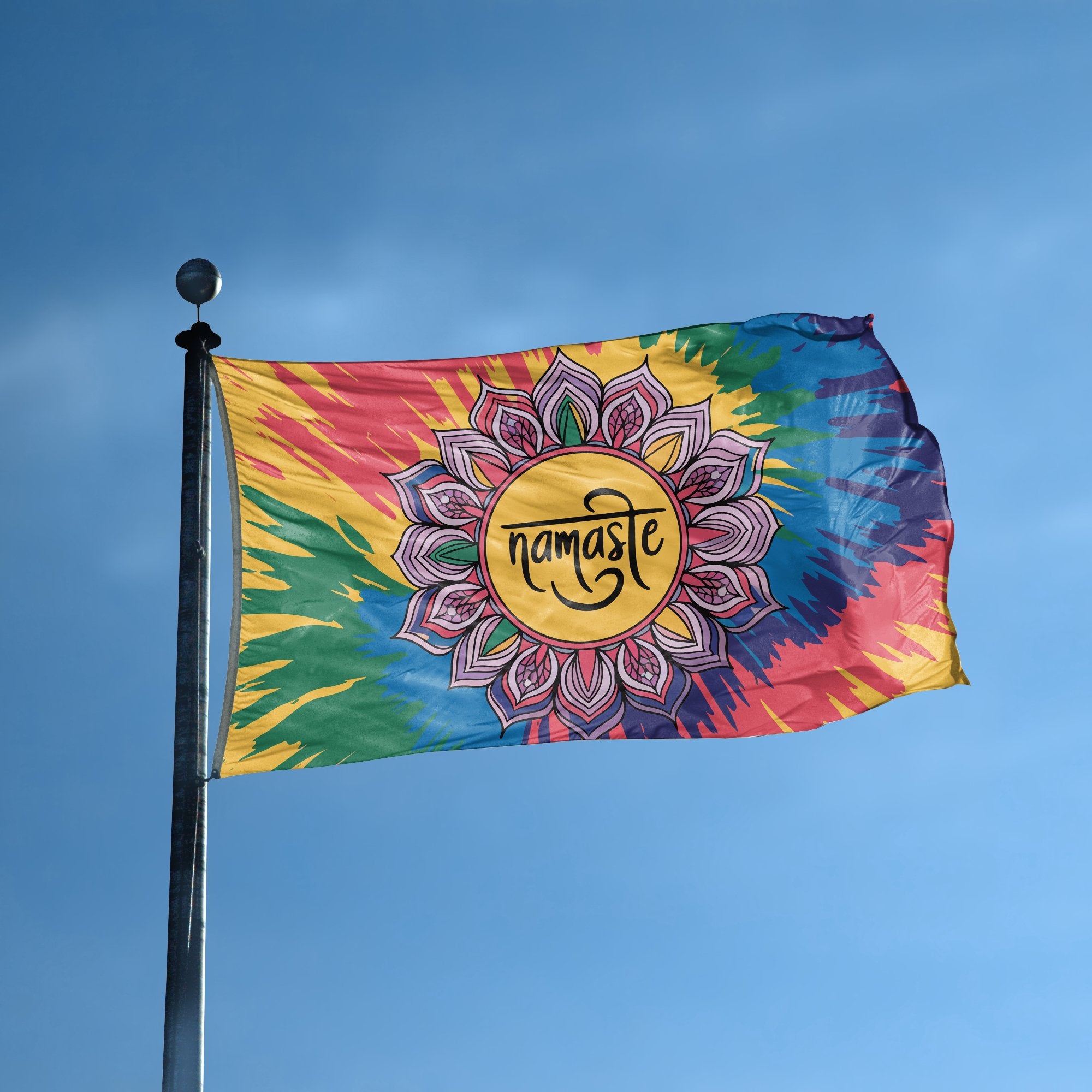 A flag with the saying "Namaste" displayed on a high pole, with a tie dye style color scheme.