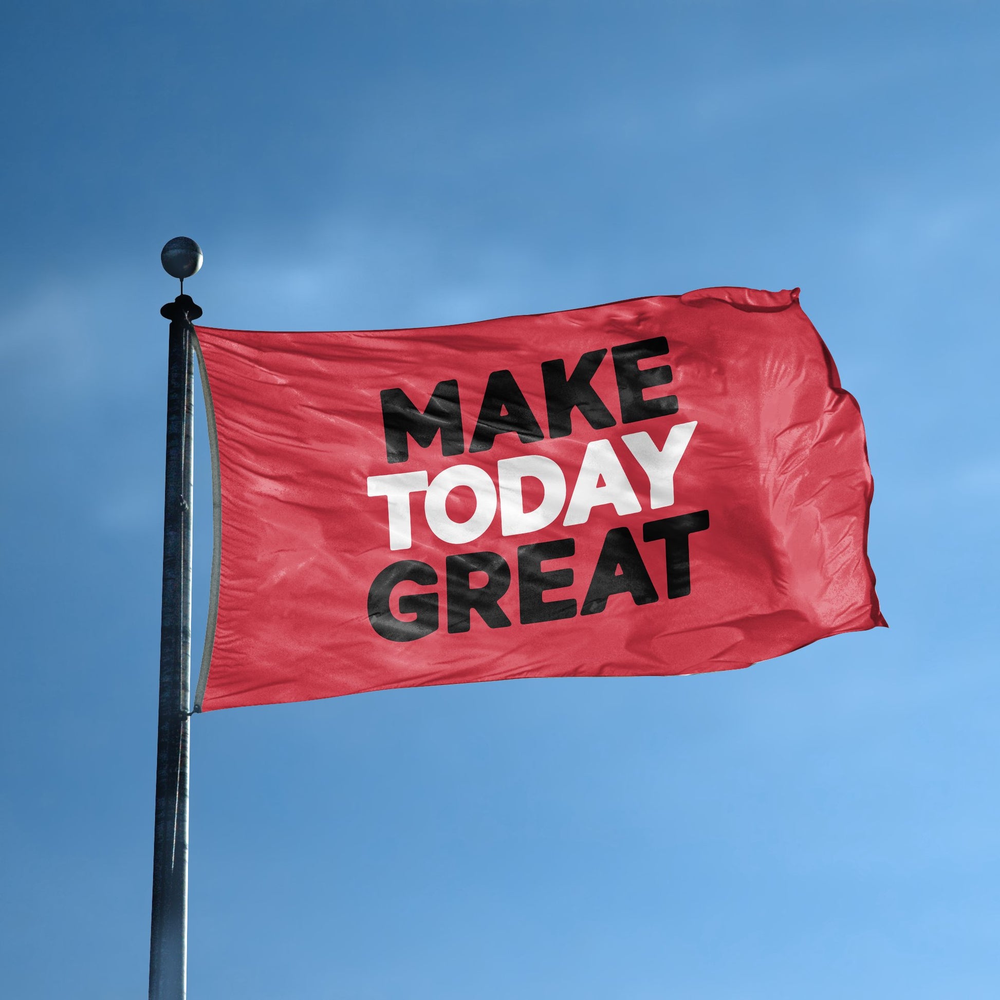 A flag with the saying "Make Today Great" displayed on a high pole, with a special occasion color scheme.