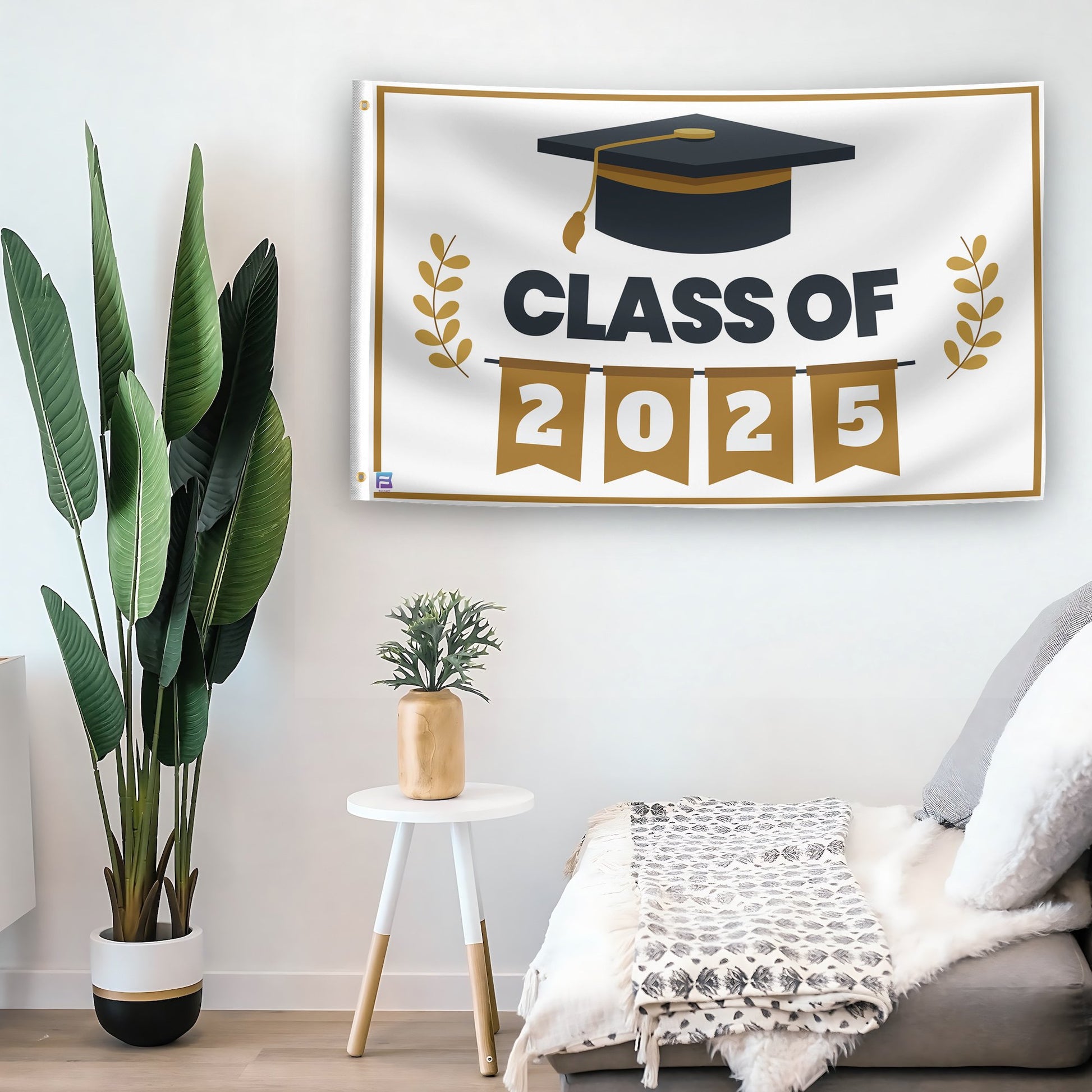 In a home setting, a flag with the saying "Class Of 2025" is mounted on a white wall by a side table.