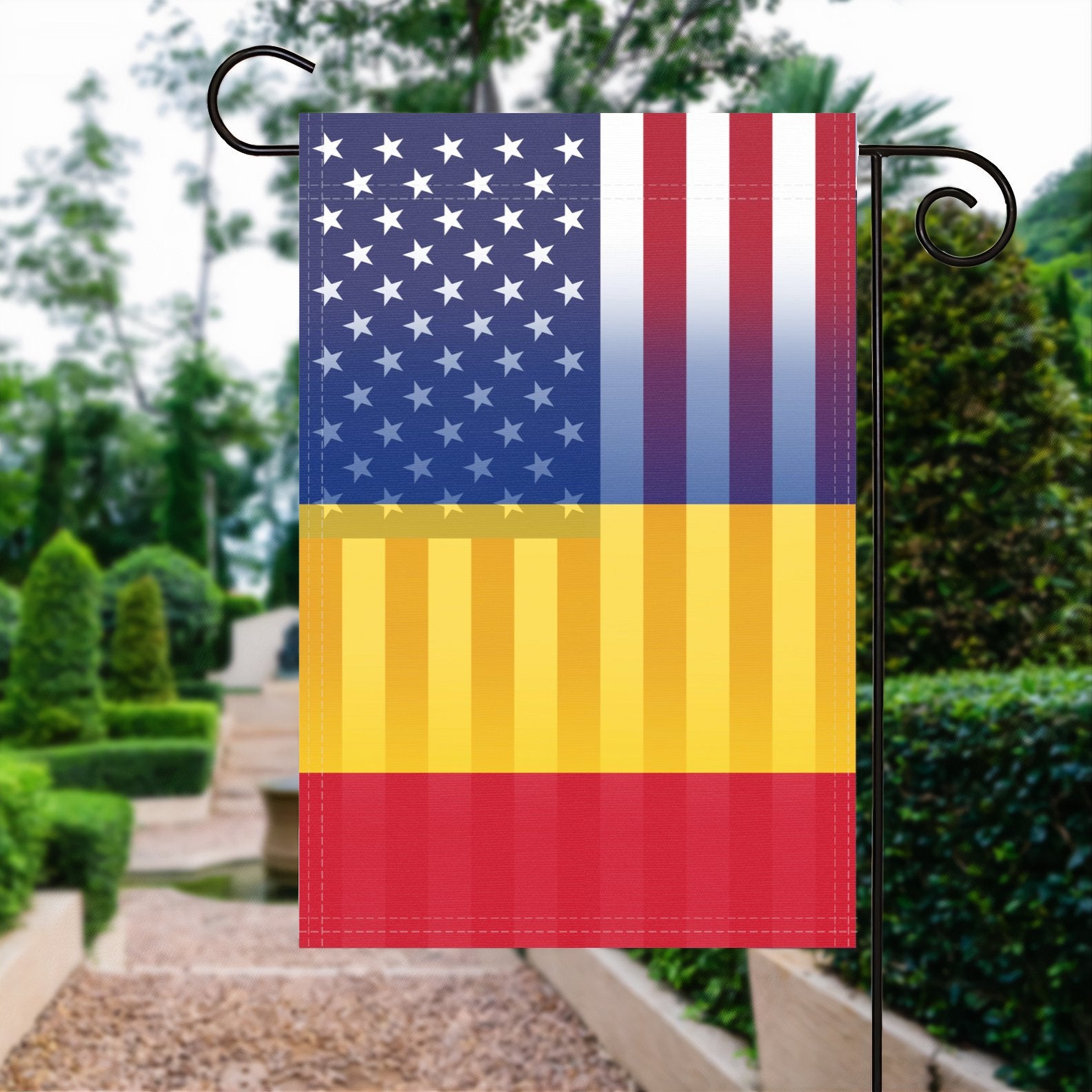 A garden flag with the Romanian American flag design seamlessly blended with the American flag, displayed in a garden.