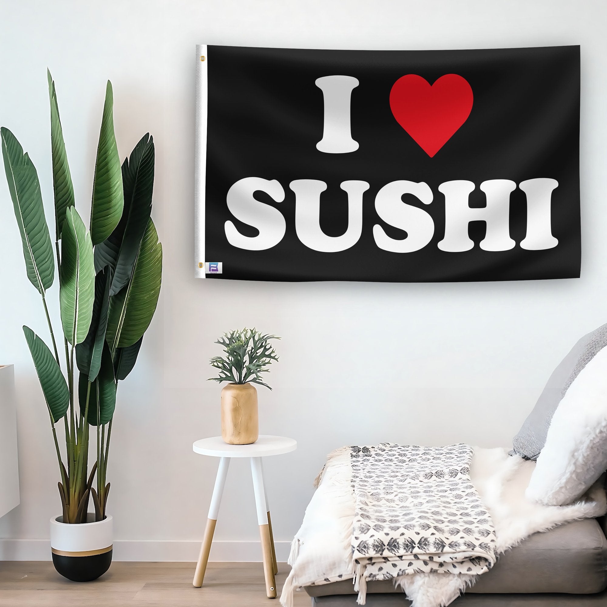 In a home setting, a flag with the saying "I Love Sushi" is mounted on a white wall by a side table.