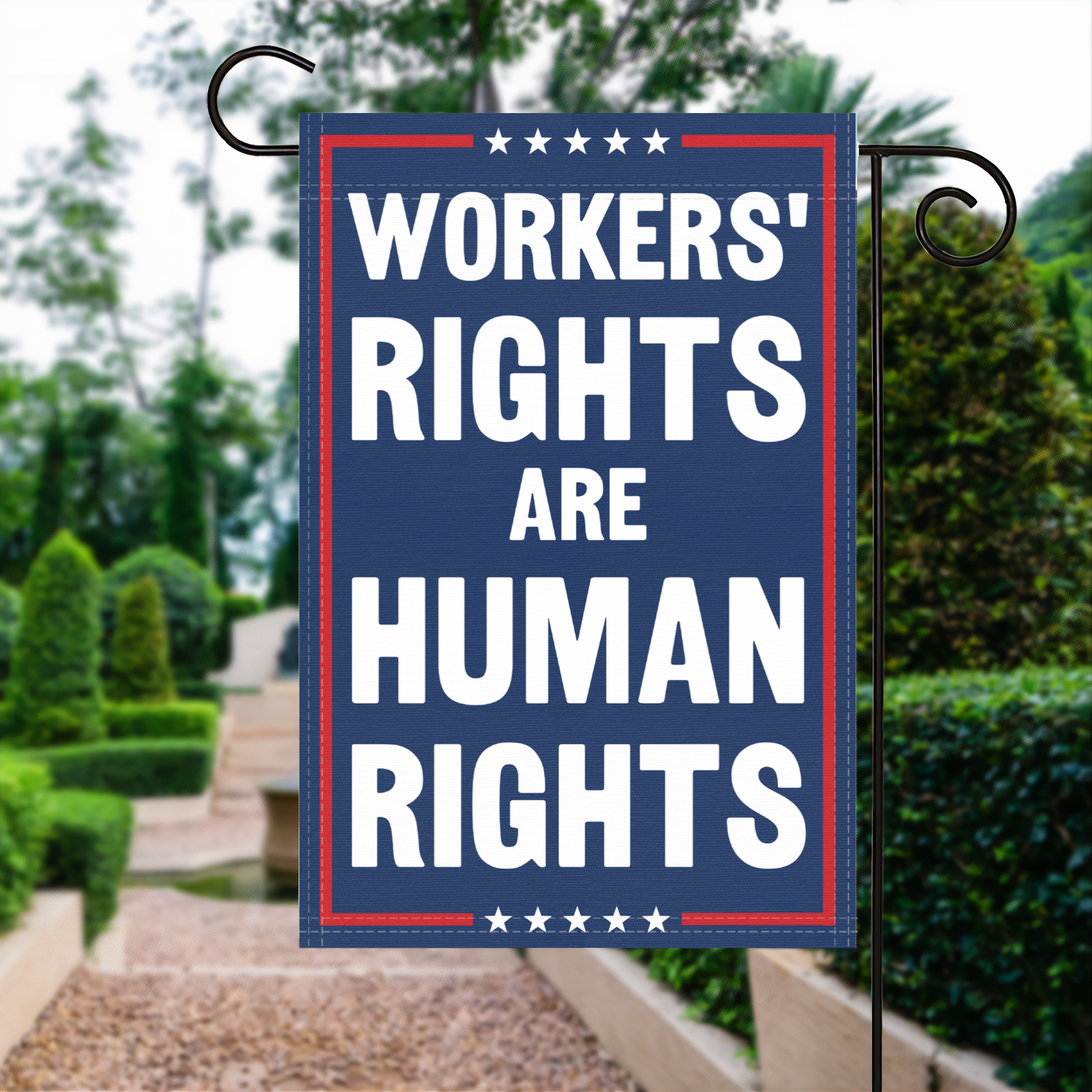 A red, white and blue political garden flag with the slogan Workers Rights Are Human Rights.