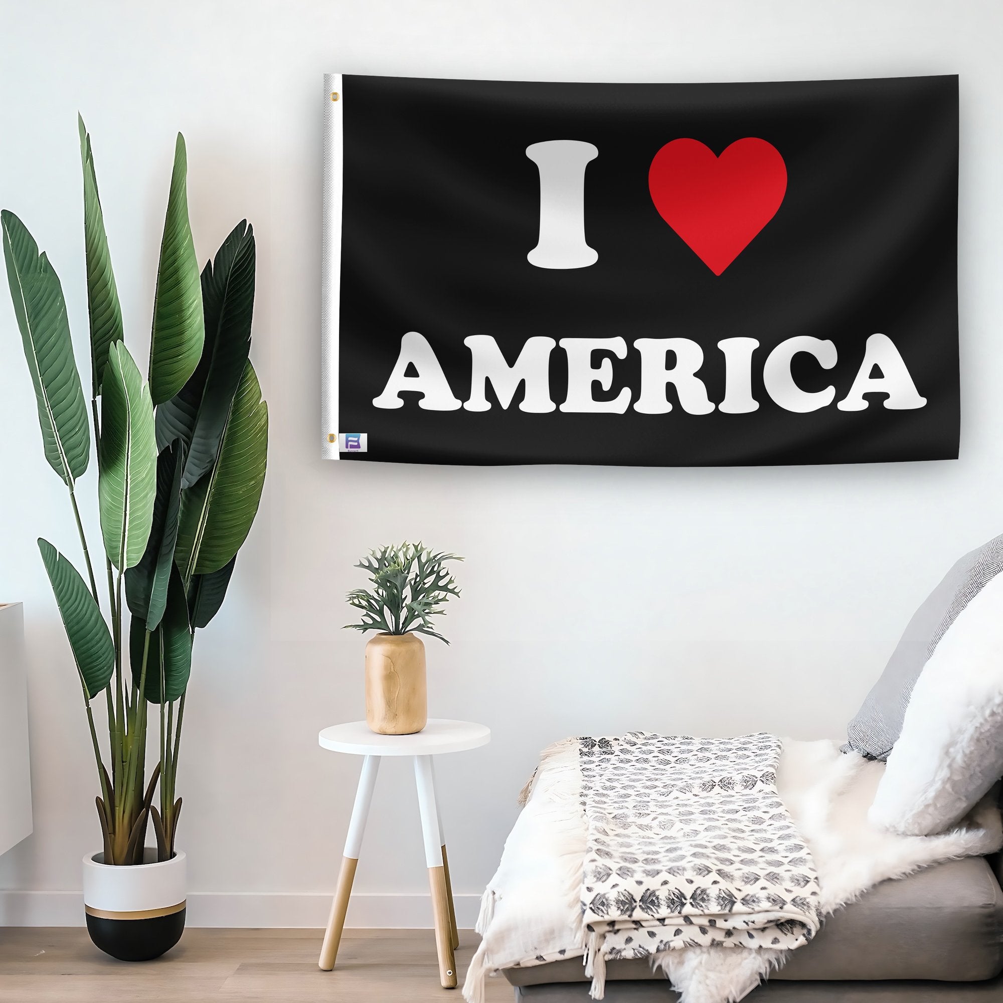 In a home setting, a flag with the saying "I Love America" is mounted on a white wall by a side table.