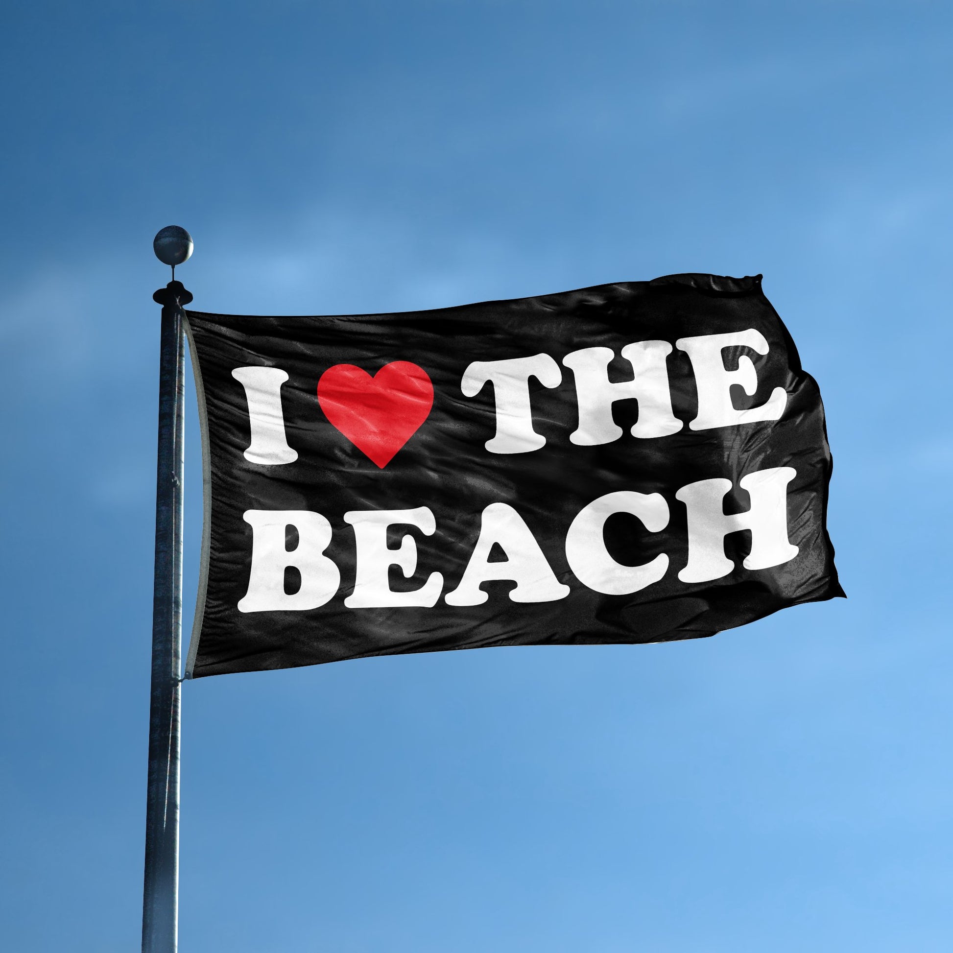 A flag with the saying "I Love The Beach" displayed on a high pole, with a black, white and red color scheme.