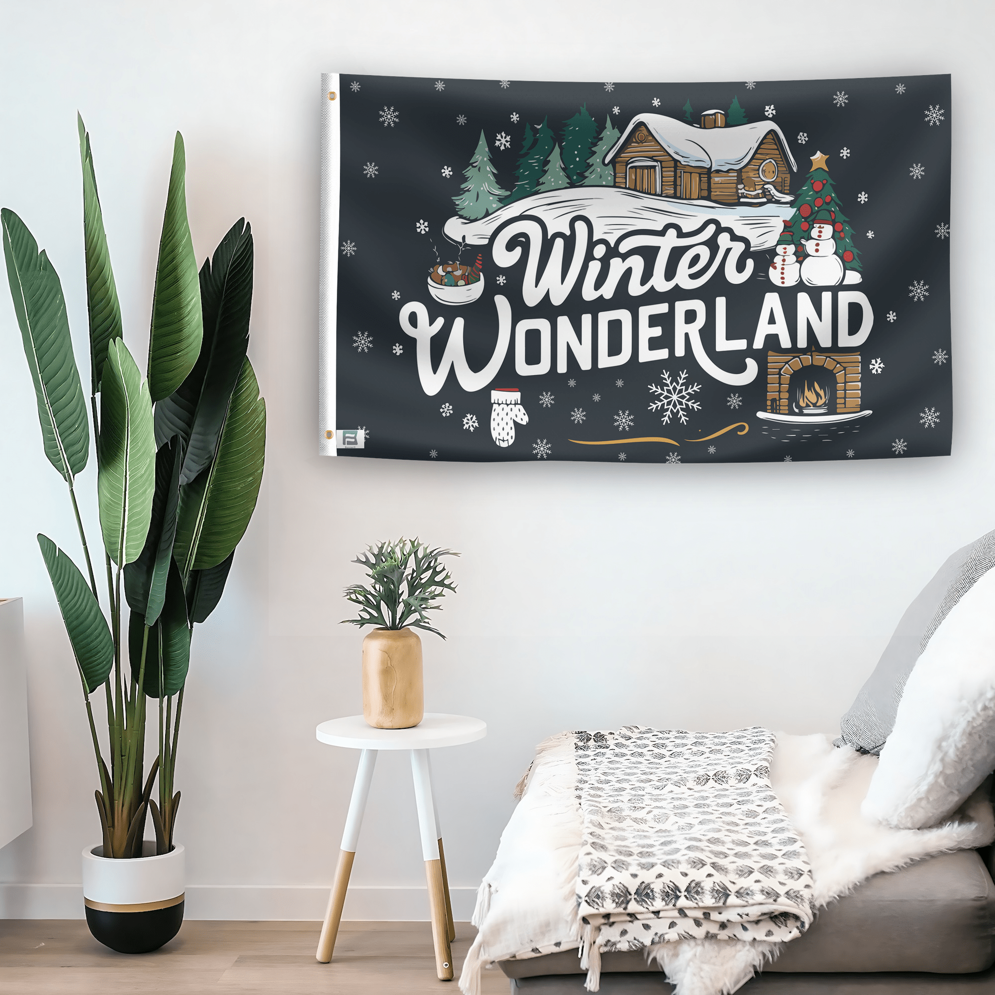 In a home setting, a flag with the saying "Winter Wonderland" is mounted on a white wall by a side table.