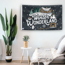 Load image into Gallery viewer, In a home setting, a flag with the saying &quot;Winter Wonderland&quot; is mounted on a white wall by a side table.
