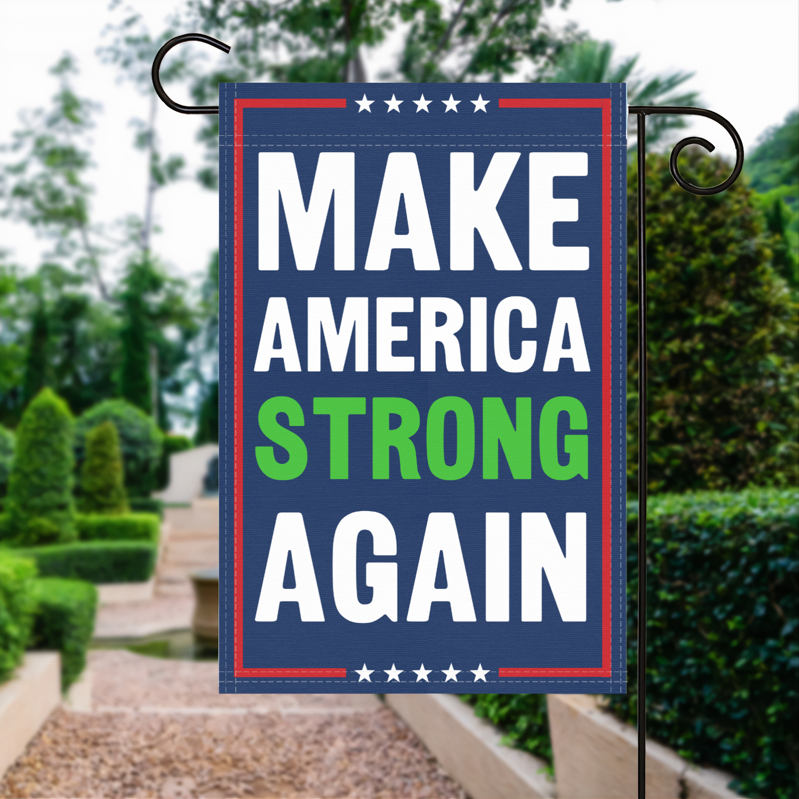 A red, white and blue political garden flag with the slogan Make America Strong Again.