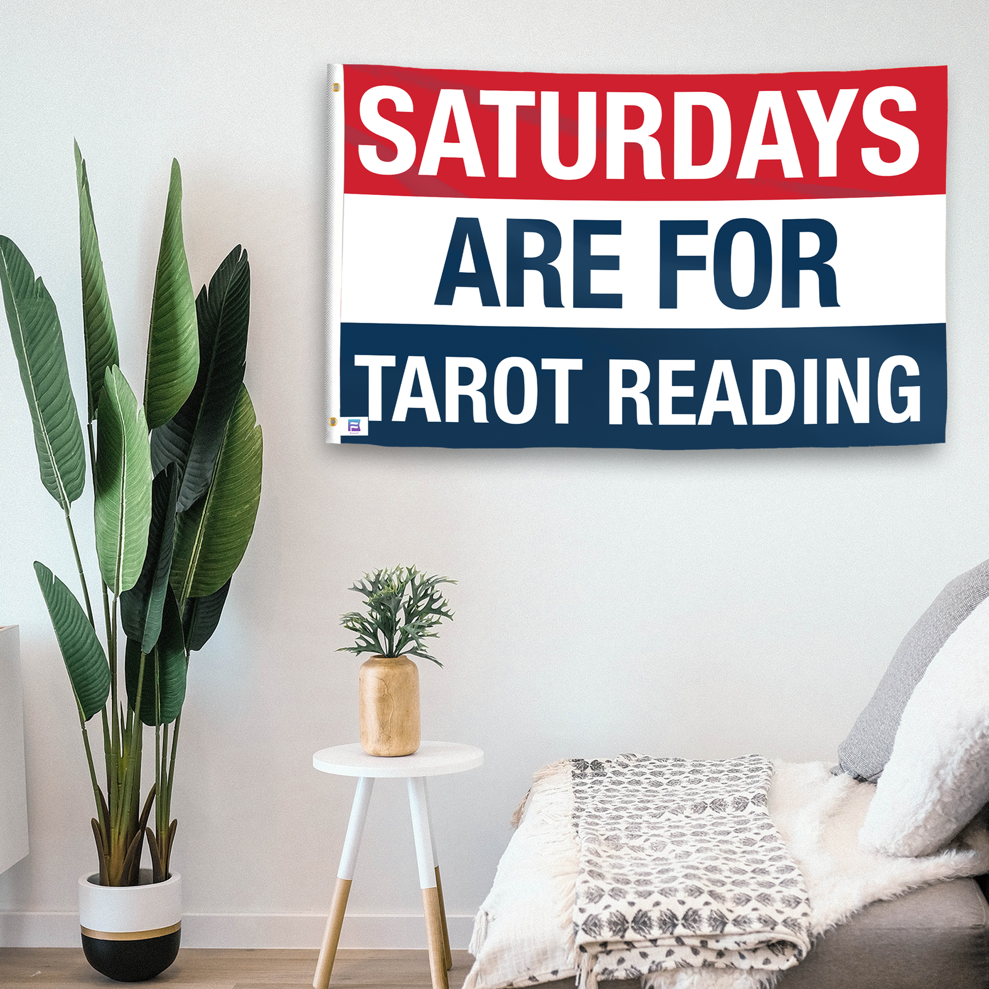 In a home setting, a flag with the saying "https://www.dropbox.com/scl/fi/870ftub68dvvss8ecl8lw/saturdays-are-for-tarot-reading_room.png?rlkey=41nqx4snusinz9wlwmhqx7d2y&raw=1" is mounted on a white wall by a side table.