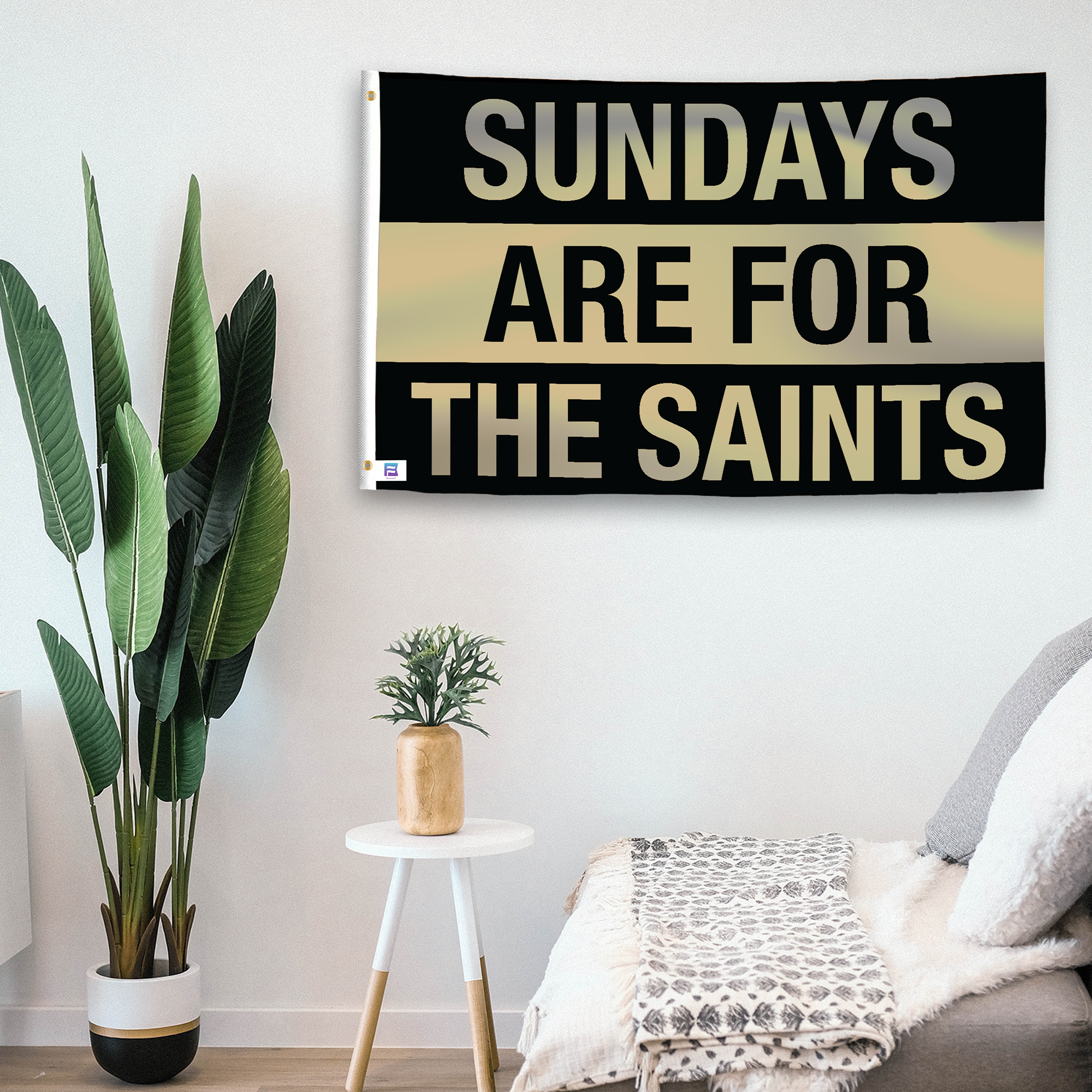 In a home setting, a flag with the saying "https://www.dropbox.com/scl/fi/kw6eo4b86k3ha78a7yqe5/sundays-are-for-the-saints_room.png?rlkey=0uyffn7ren4jd0awmqbq9j3da&raw=1" is mounted on a white wall by a side table.