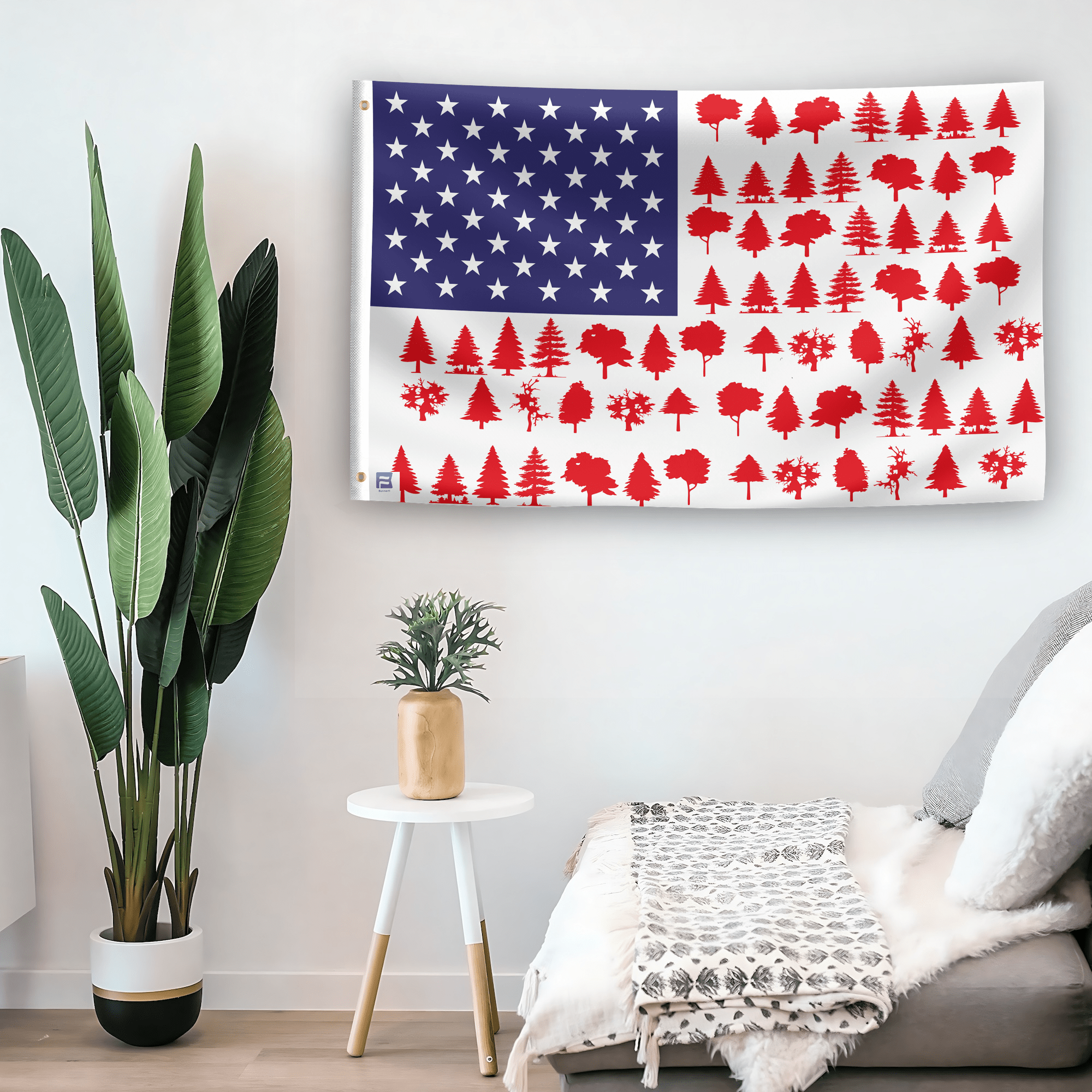 In a home setting, an american flag with the theme "Tree Stripes American" is mounted on a white wall by a side table.