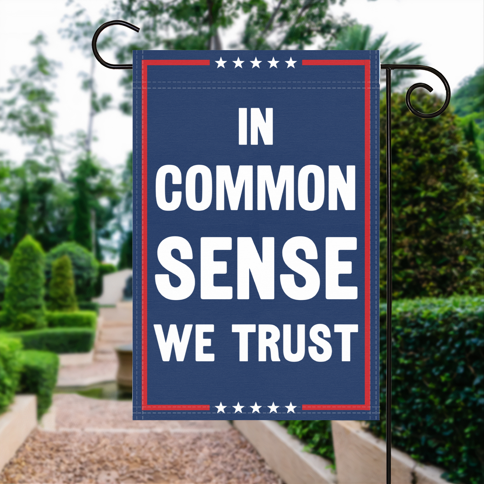 A red, white and blue political garden flag with the slogan In Common Sense We Trust.