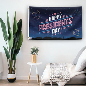 In a home setting, a flag with the saying "Presidents' Day" is mounted on a white wall by a side table.