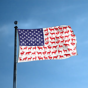 An american flag with the red stripes changed to match the theme "Deer Stripes American" displayed on a high pole.