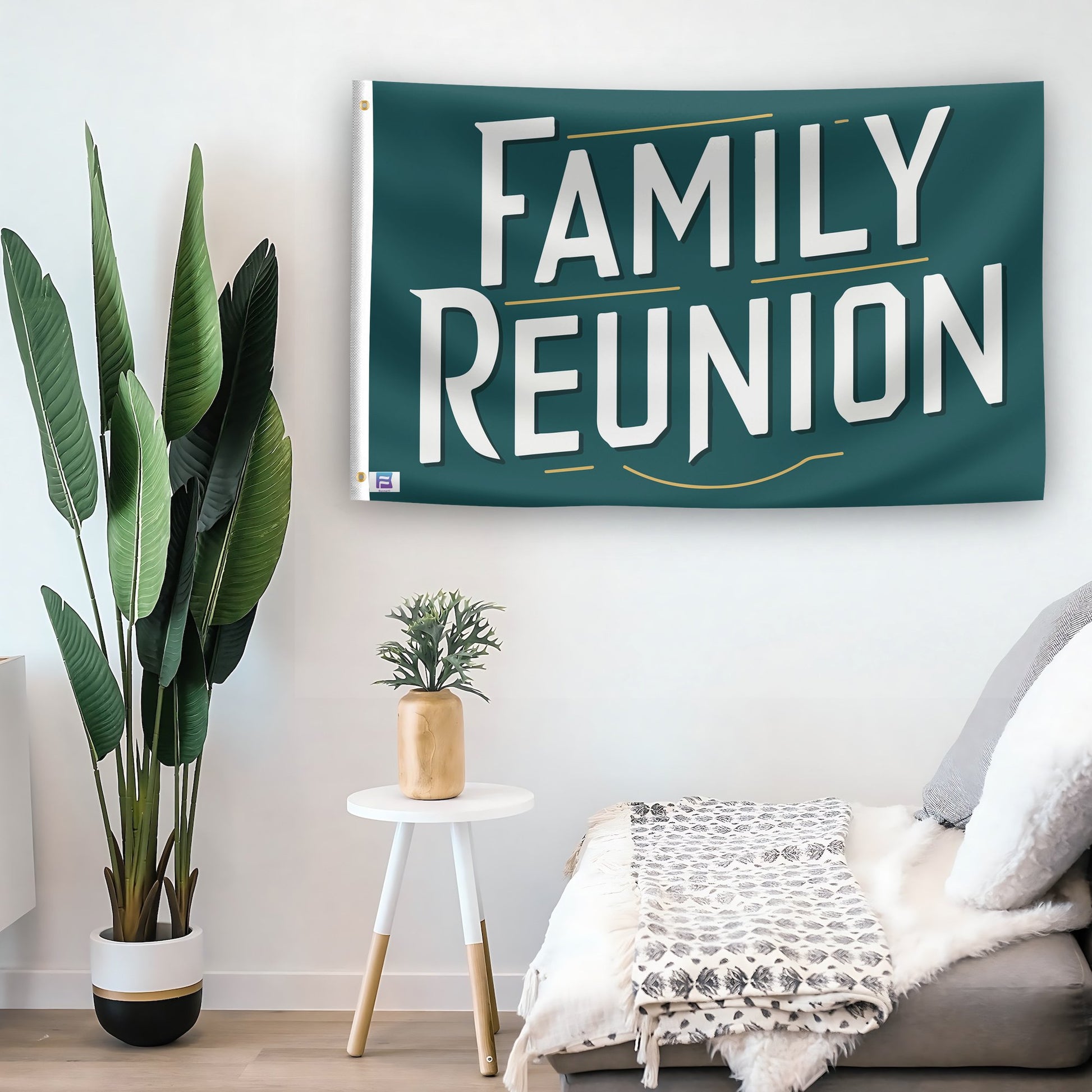 In a home setting, a flag with the saying "Family Reunion" is mounted on a white wall by a side table.