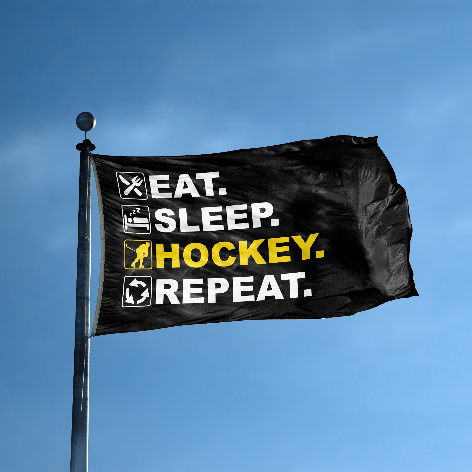 A flag with the saying "Eat Sleep Hockey Repeat" displayed on a high pole, with a black, white and themed color scheme.