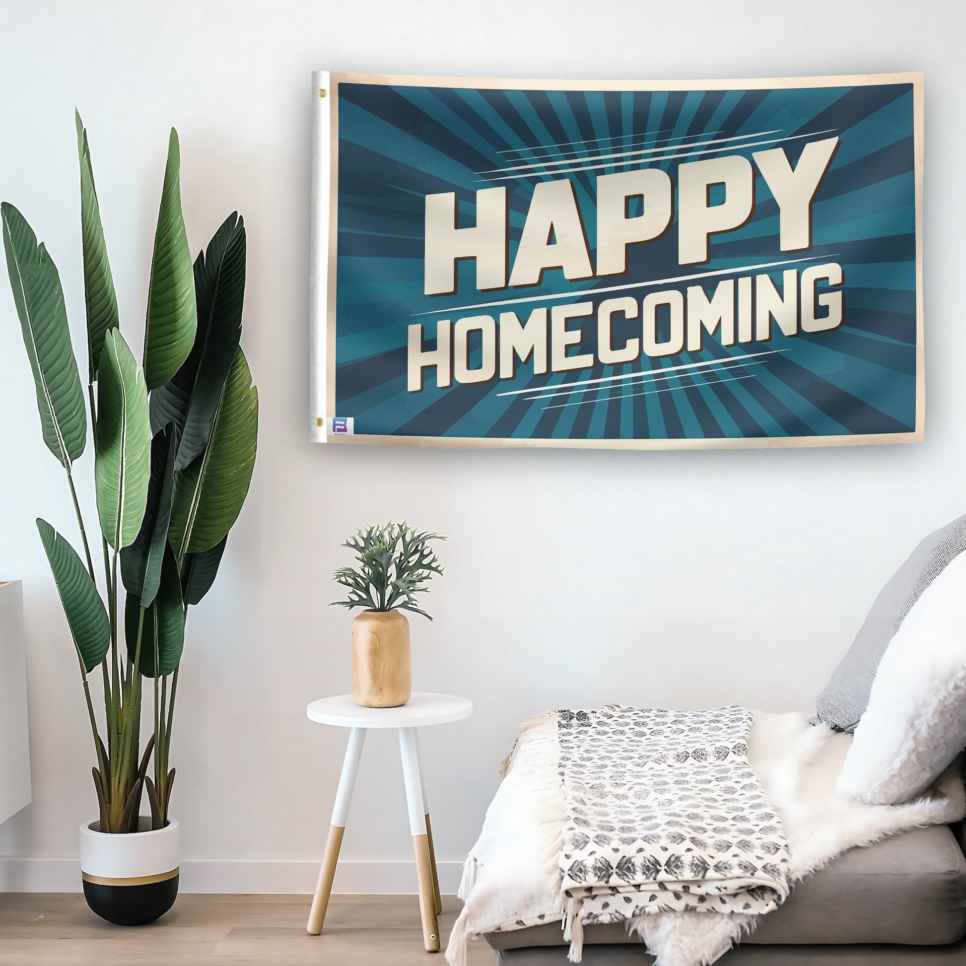 In a home setting, a flag with the saying "Happy Homecoming" is mounted on a white wall by a side table.