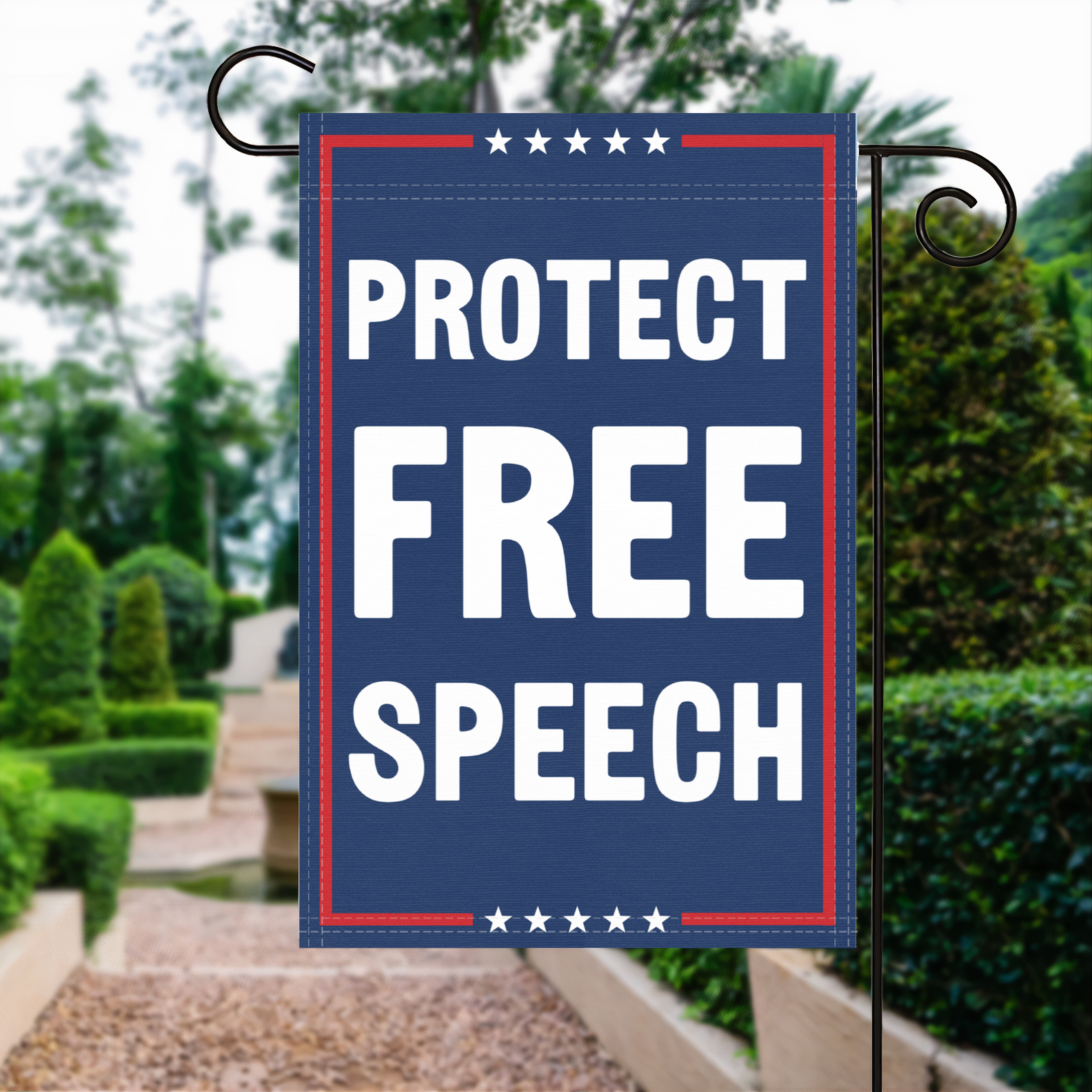 A red, white and blue political garden flag with the slogan Protect Free Speech.