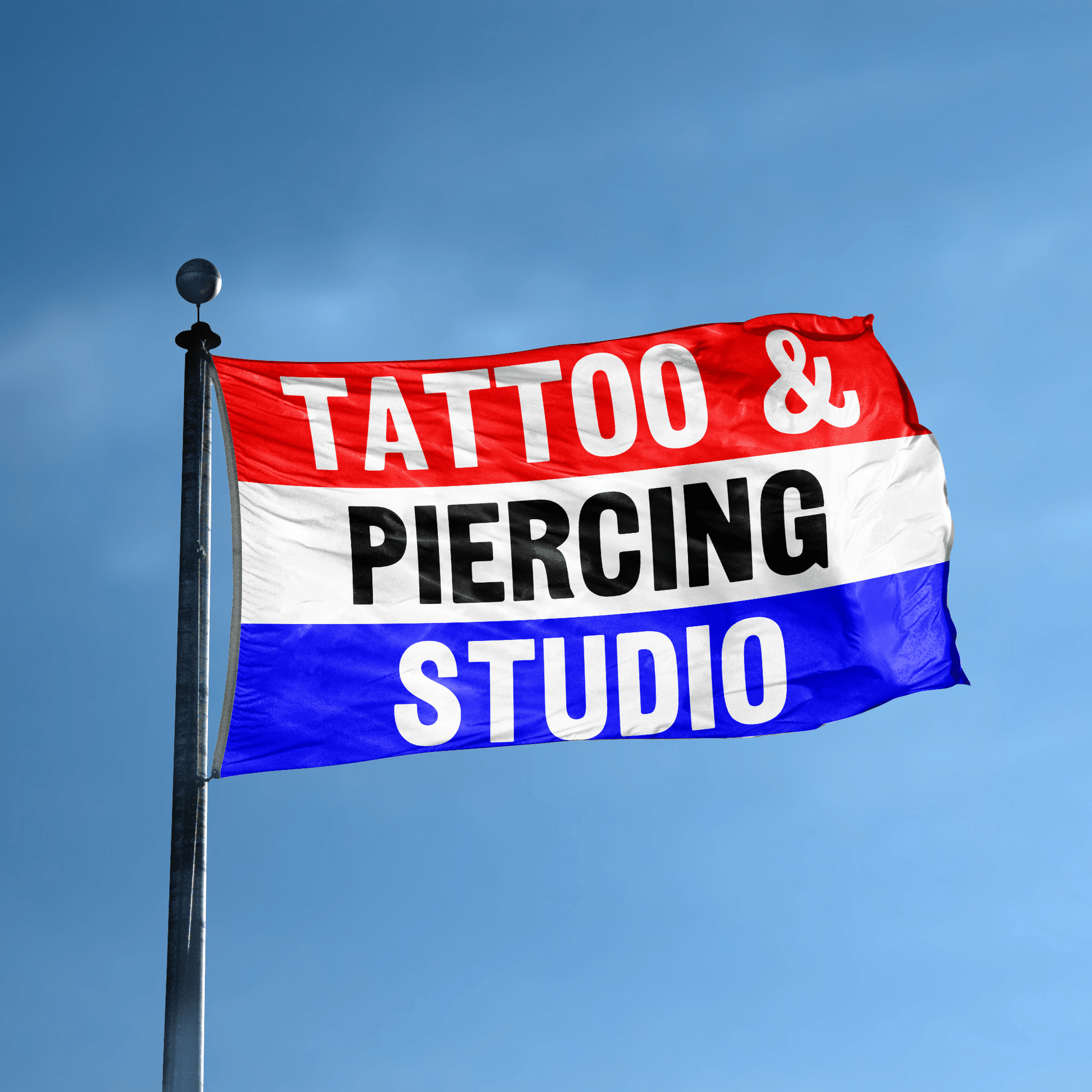 A business banner with the saying "Tattoo And Piercing Studio" displayed on a high pole, with a red, white, and blue color scheme.