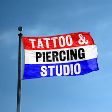 Load image into Gallery viewer, A business banner with the saying &quot;Tattoo And Piercing Studio&quot; displayed on a high pole, with a red, white, and blue color scheme.
