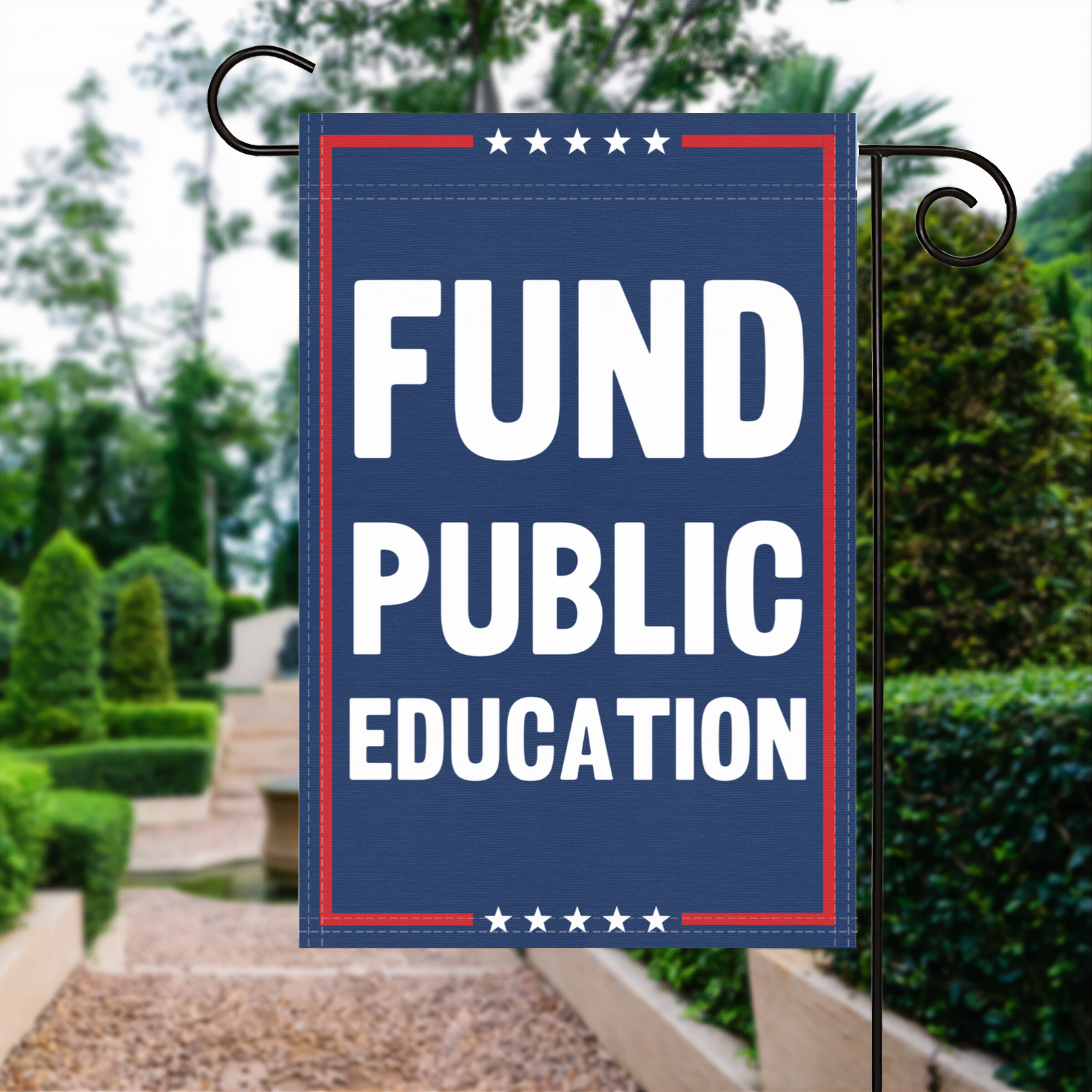 A red, white and blue political garden flag with the slogan Fund Public Education.