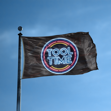 Load image into Gallery viewer, A flag with the saying &quot;Tool Time&quot; displayed on a high pole, with a neon style color scheme.
