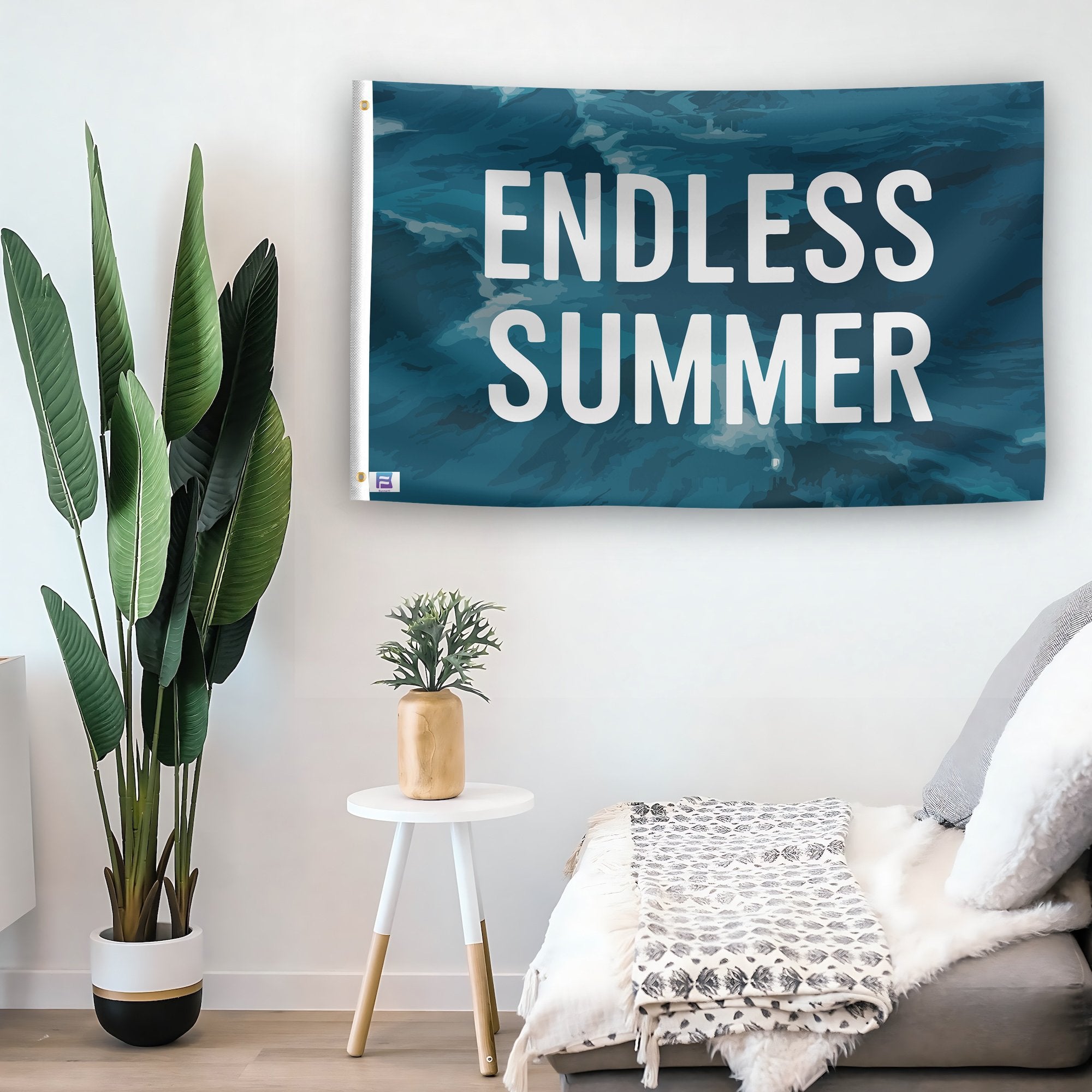 In a home setting, a flag with the saying "Endless Summer" is mounted on a white wall by a side table.