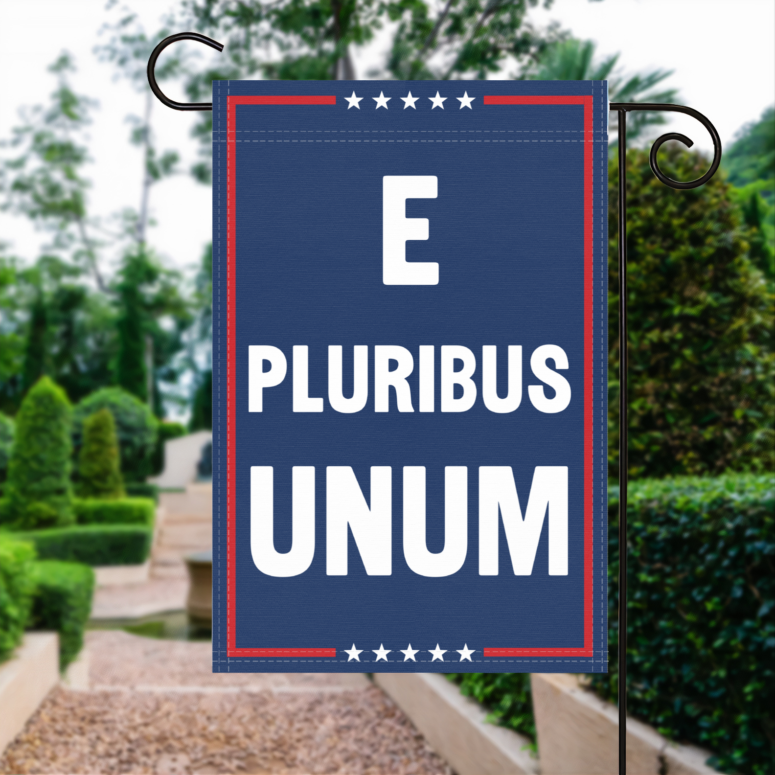 A red, white and blue political garden flag with the slogan E Pluribus Unum.